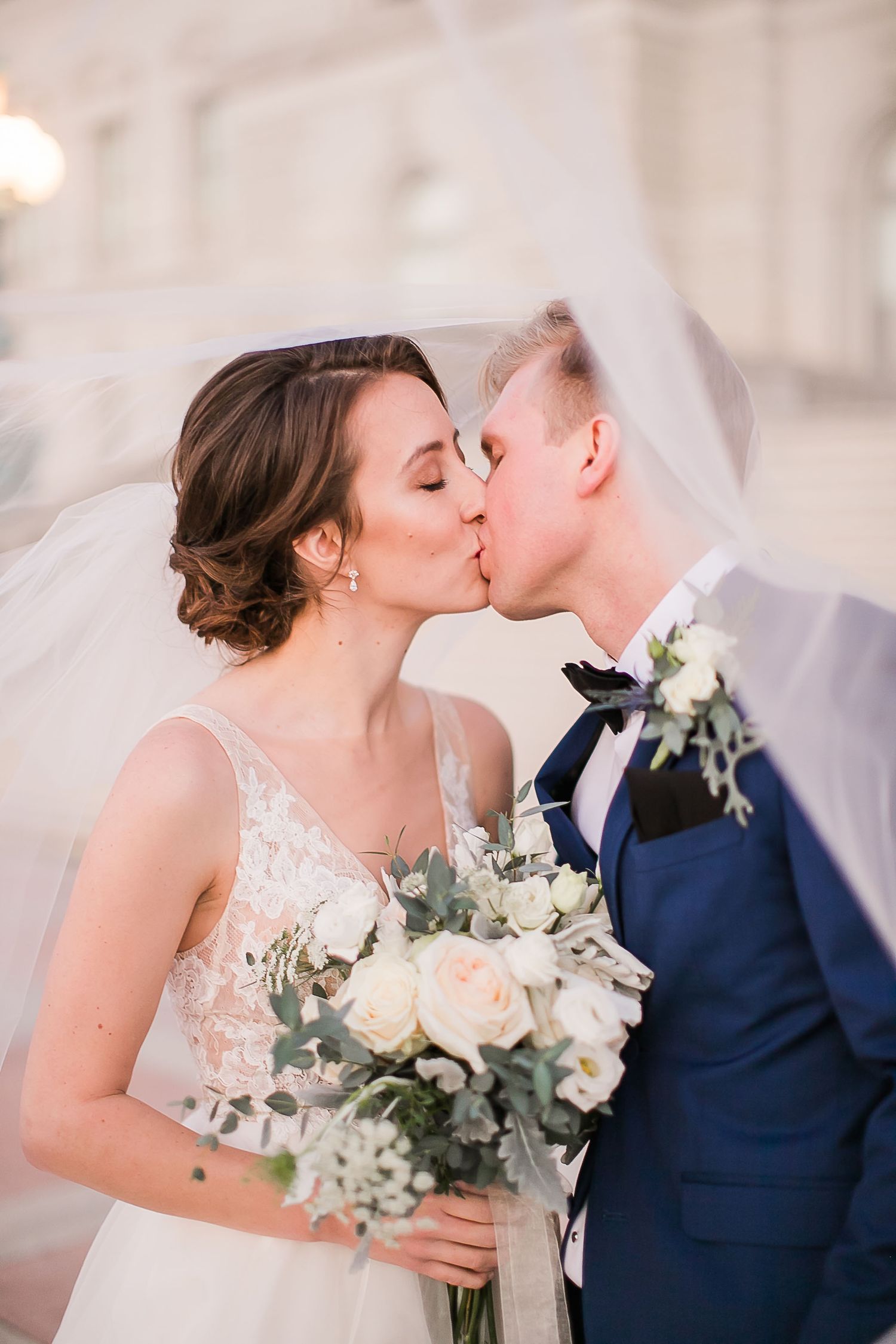 A romantic series of wedding photos shows a couple sharing a tender kiss while holding a beautiful white and green bouquet.