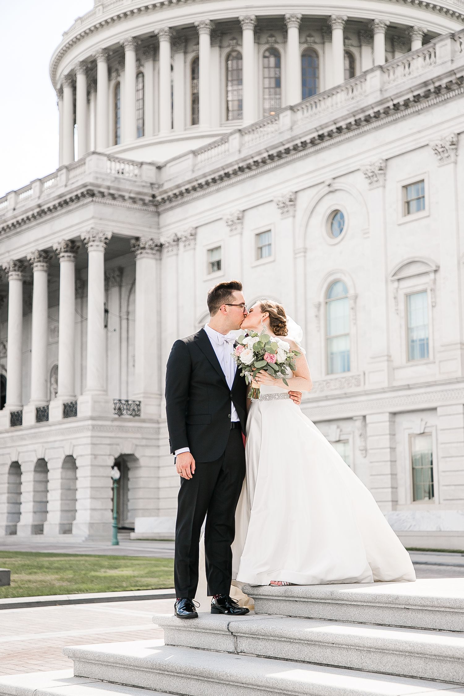 A romantic wedding portrait series on the white marble steps of the US Capitol building in Washington DC.
