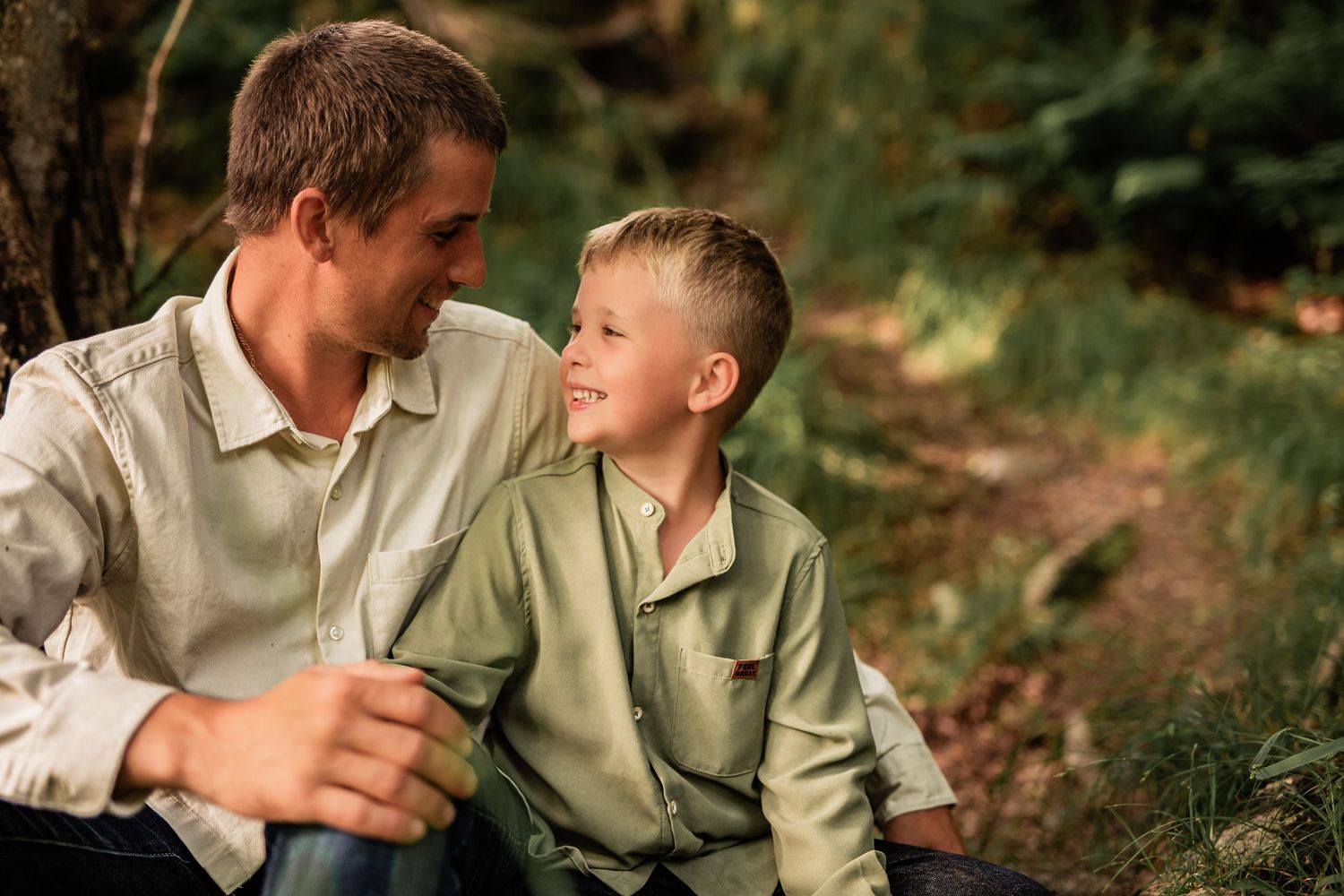 Parent and child sharing a warm moment together in casual outdoor setting.