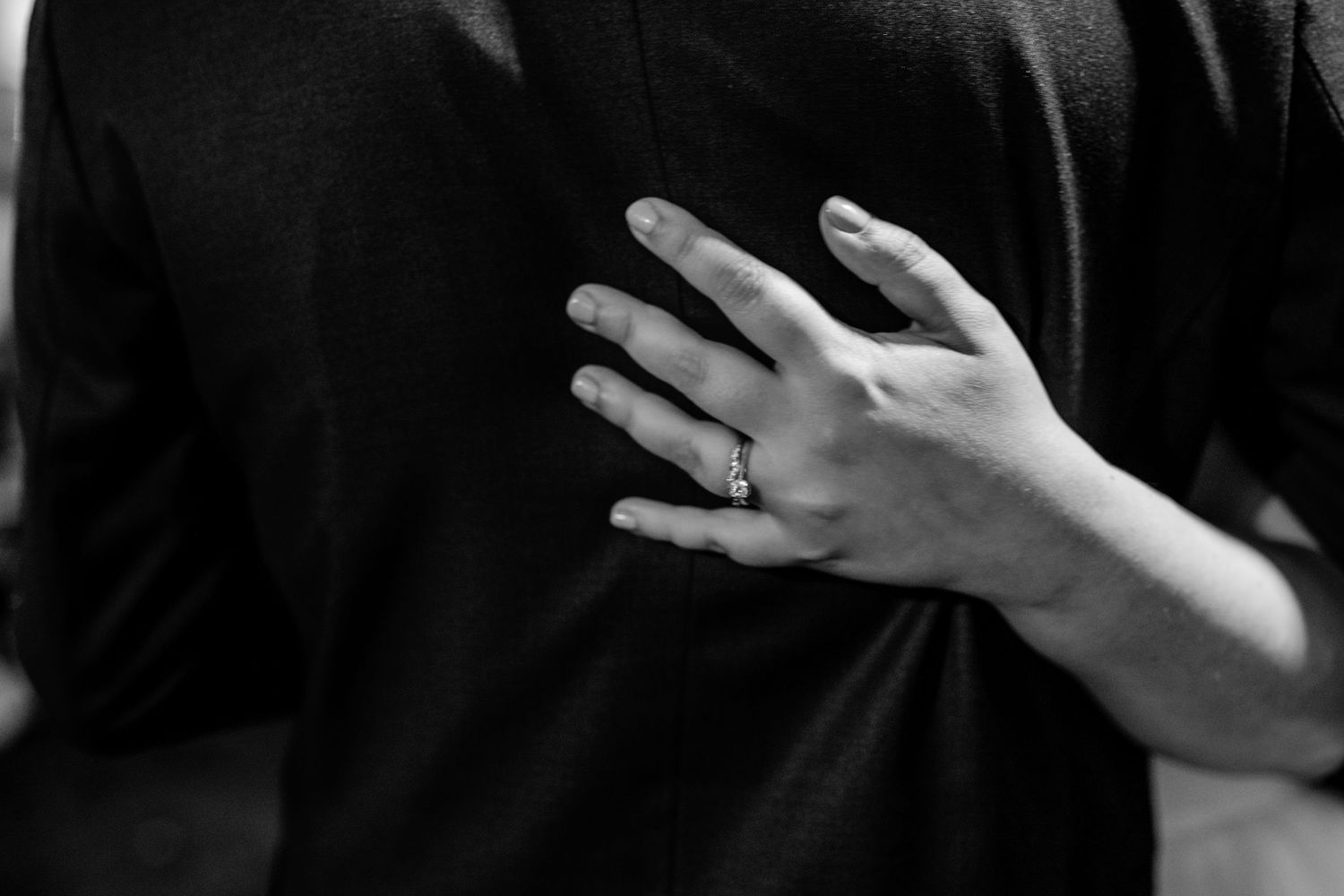 Series of black and white shots showing hands gesturing during a wedding ceremony.