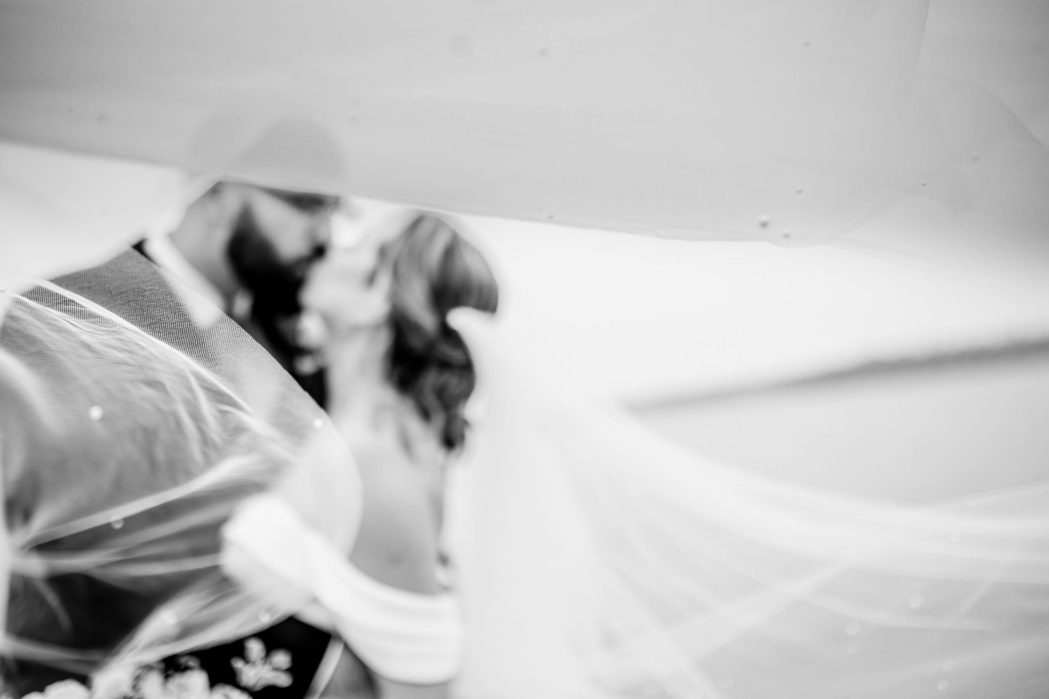 Abstract black and white photograph of flowing wedding veil fabric.
