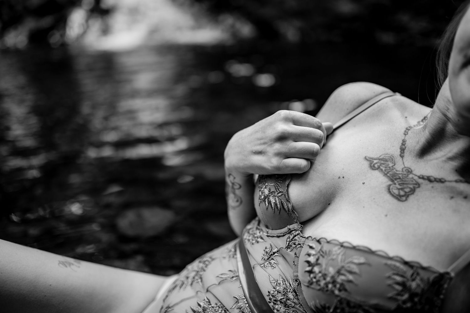 Black and white artistic photo highlighting decorative tattoo details.