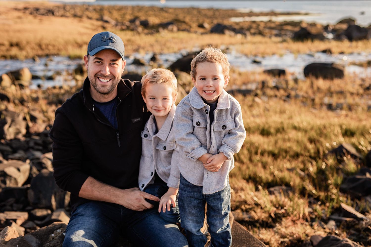 Family enjoying quality time together during an outdoor sunset photo session.