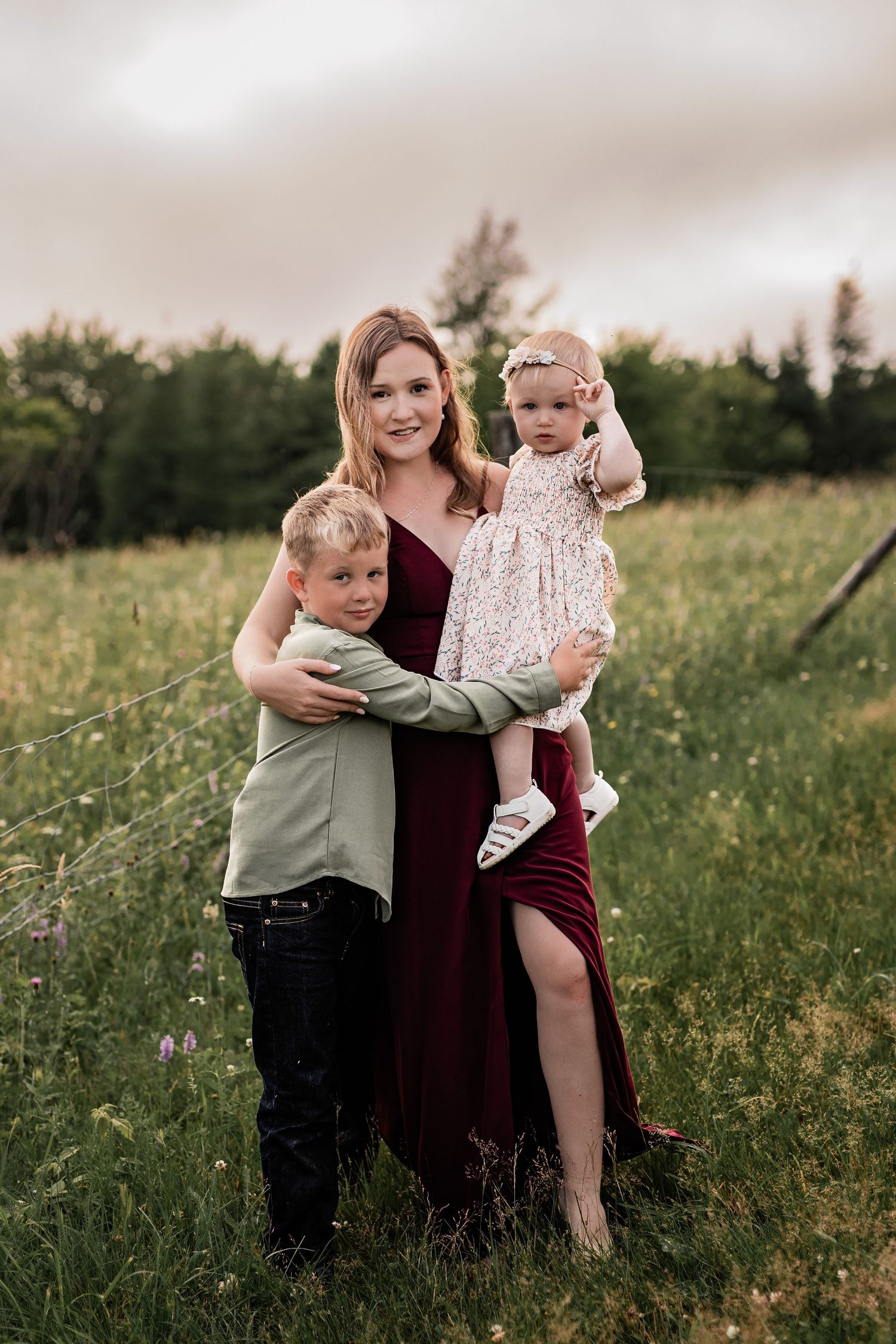 Sweet family interactions in a green summer meadow during golden hour.