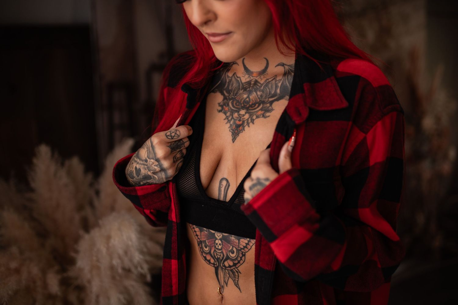 A dramatic portrait series in dark tones featuring red velvet clothing and ornate tattoo designs in a gothic style.