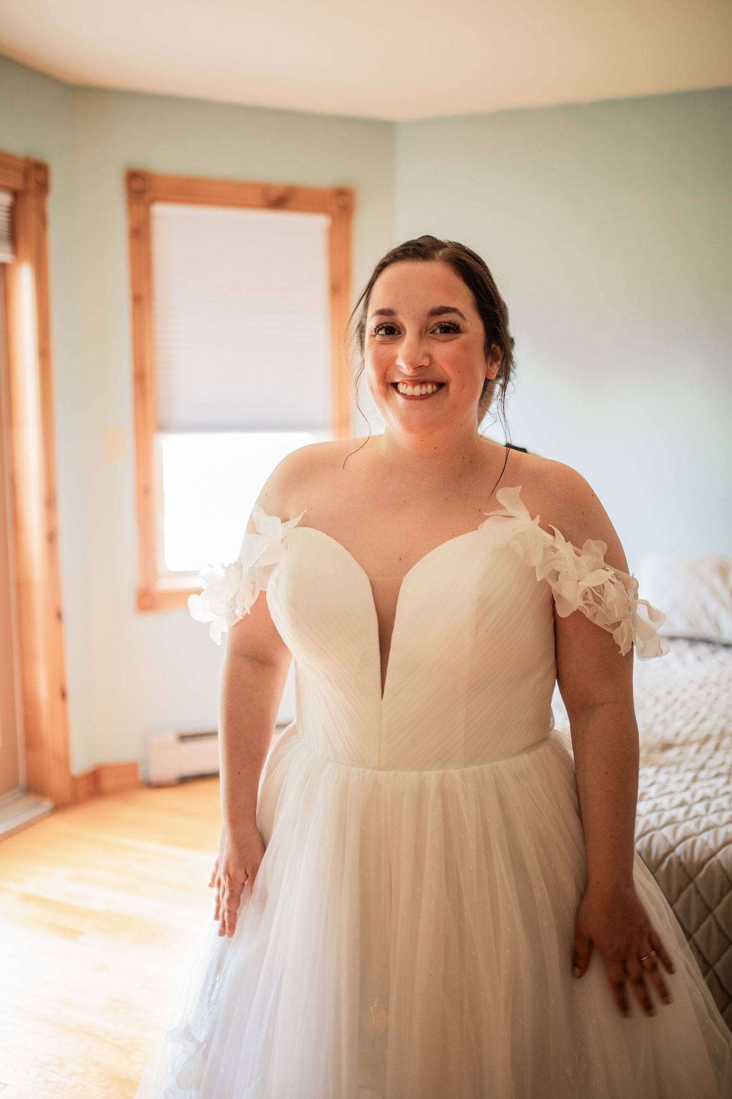 A joyful moment captured in a sunlit room with wooden window frames.
