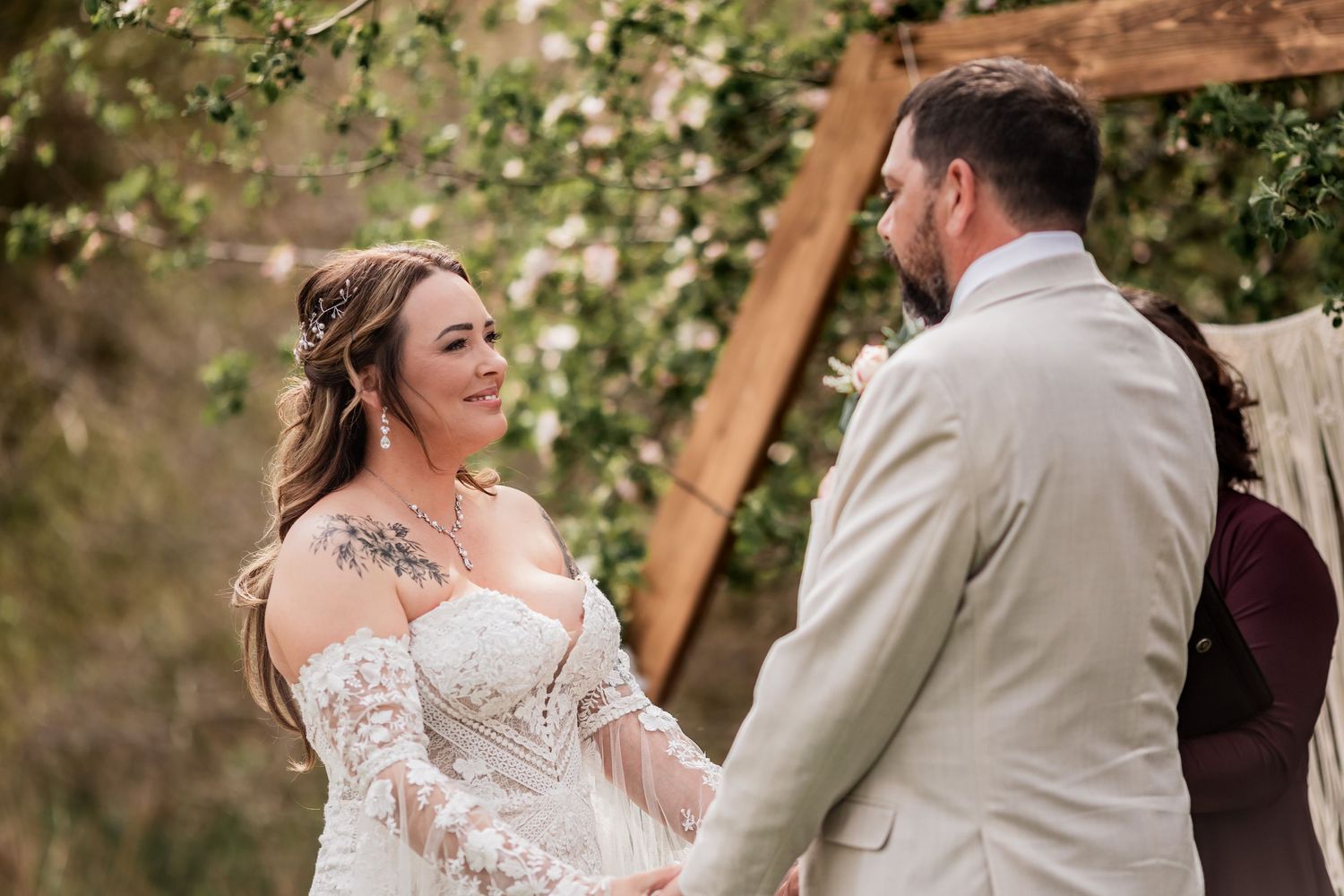 A joyful moment between a couple during their outdoor wedding ceremony.