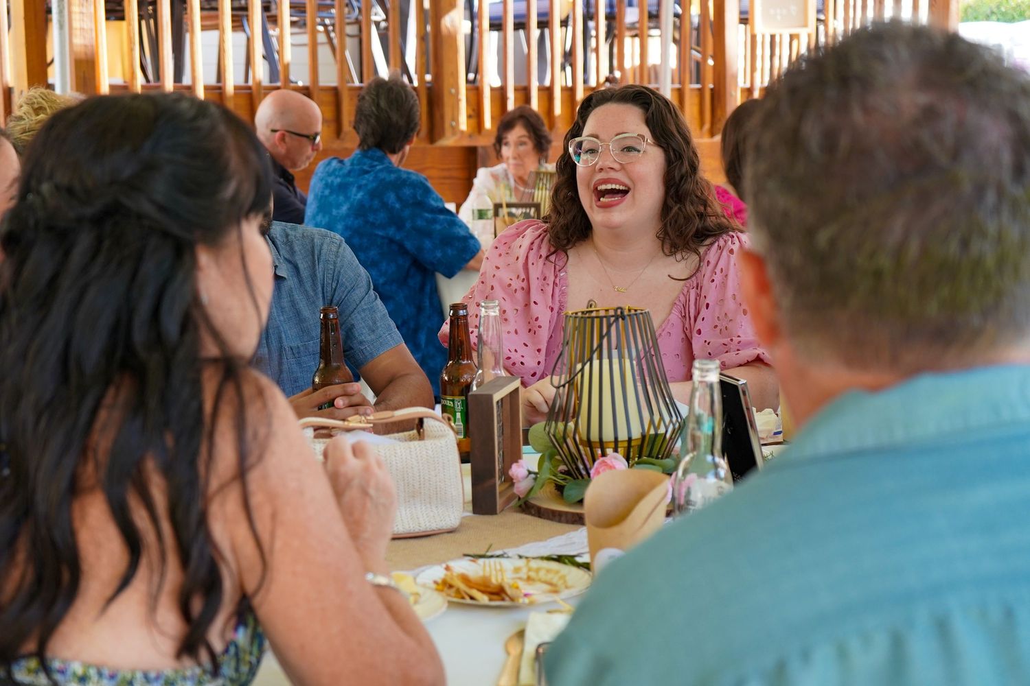 Wedding reception guests enjoying a lively moment during dinner celebration.