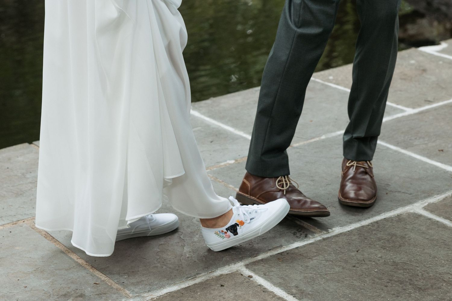 Couple enjoys showing off the custom shoes they choose to wear for their elopement. By Vermont Wedding Photographer