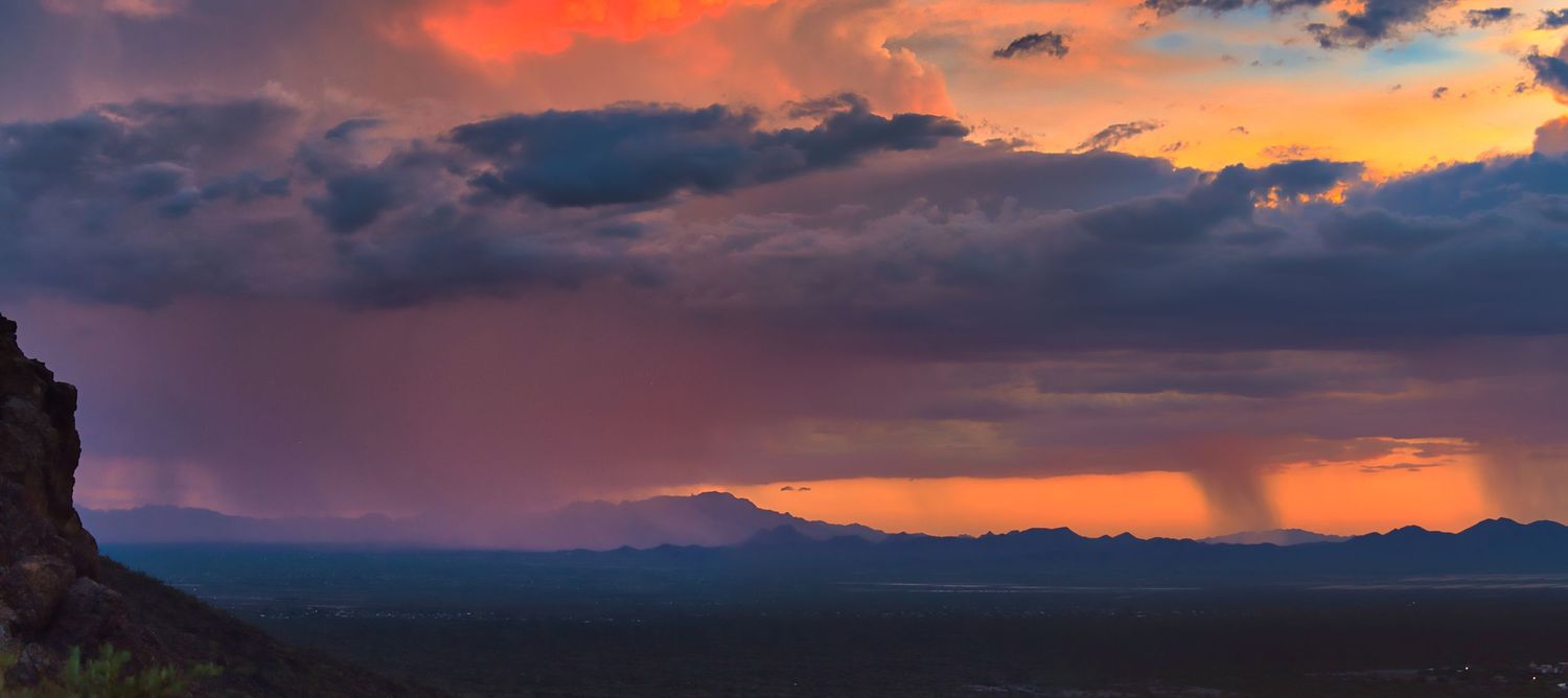 colorful rainstorm at sunset in the desert