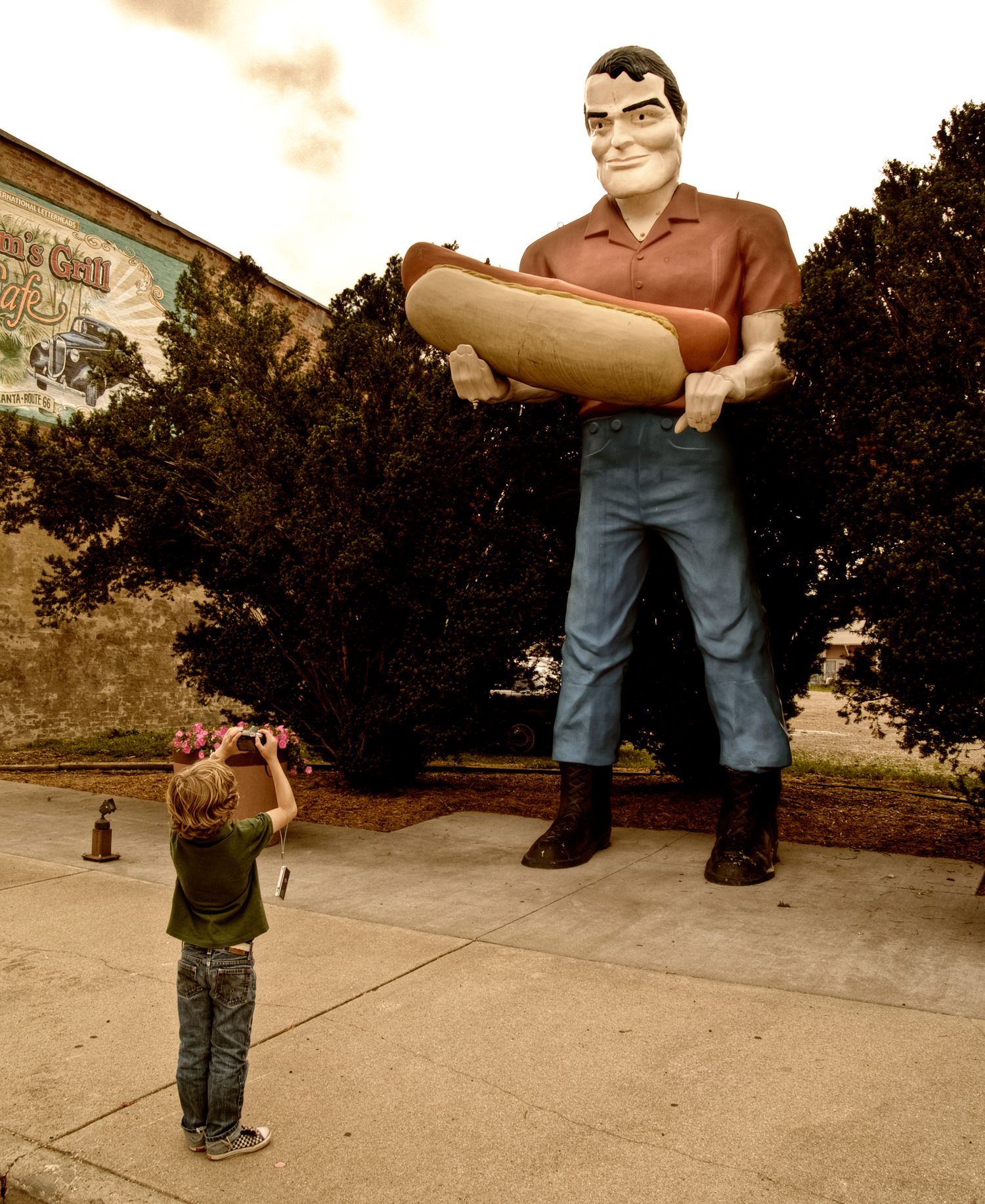 American Route 66 Illinois, small boy taking photo of a giant.