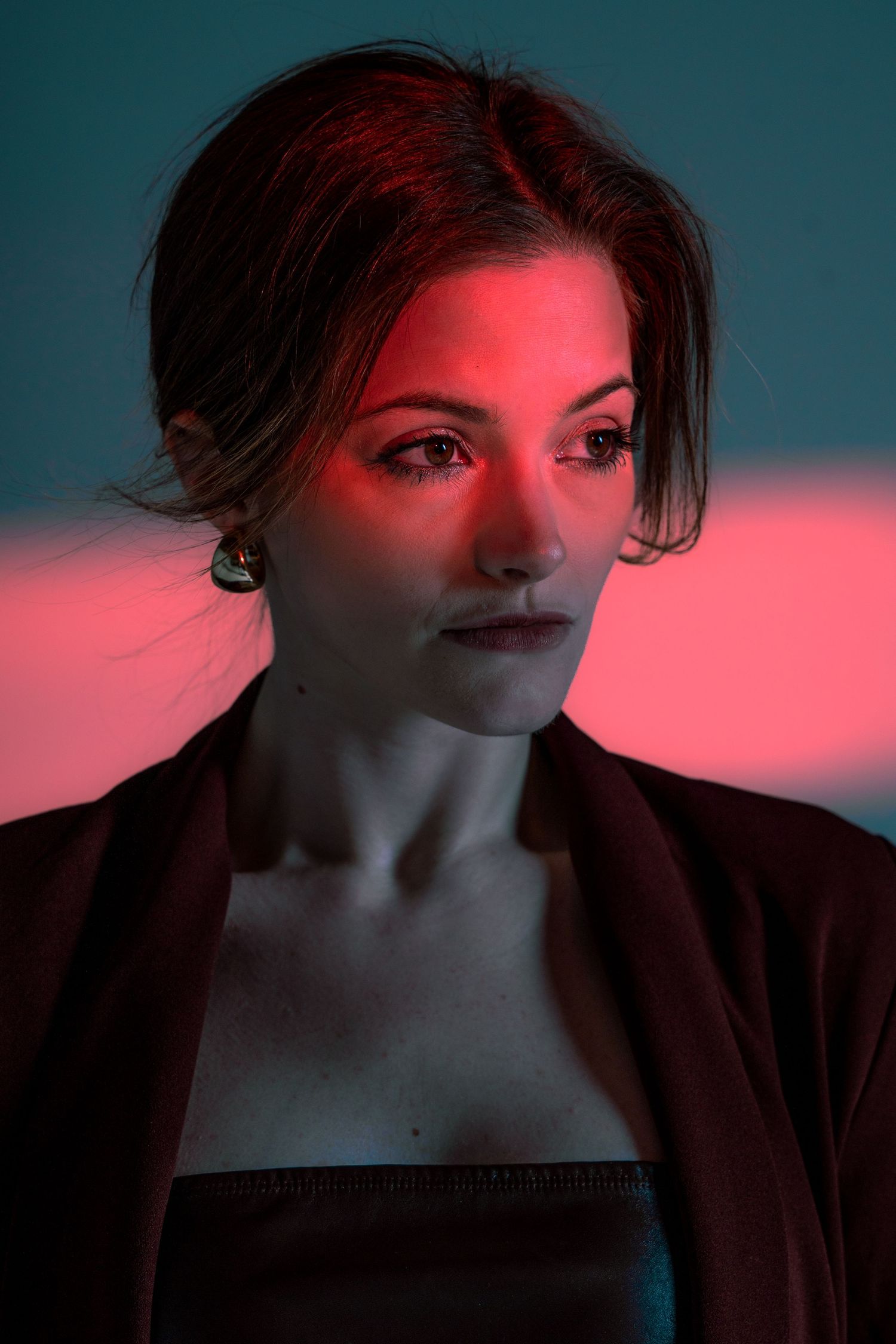 Moody portraits with red lighting creating atmospheric shadows and contrast.