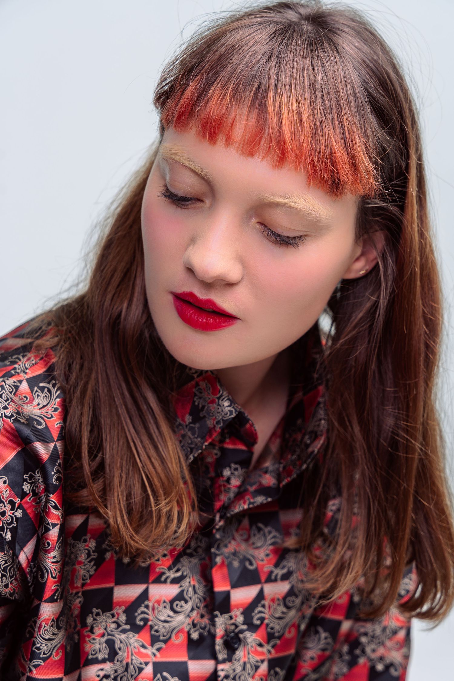 Close-up beauty shots with red lipstick and floral pattern clothing.