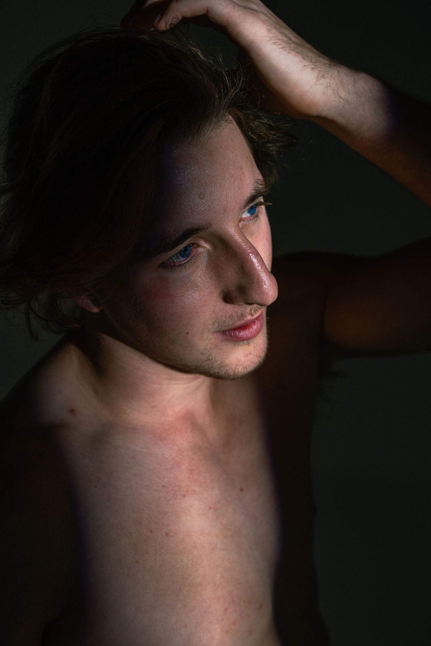 Artistic portrait series showing different angles of a person in dramatic low-key lighting against a dark background.