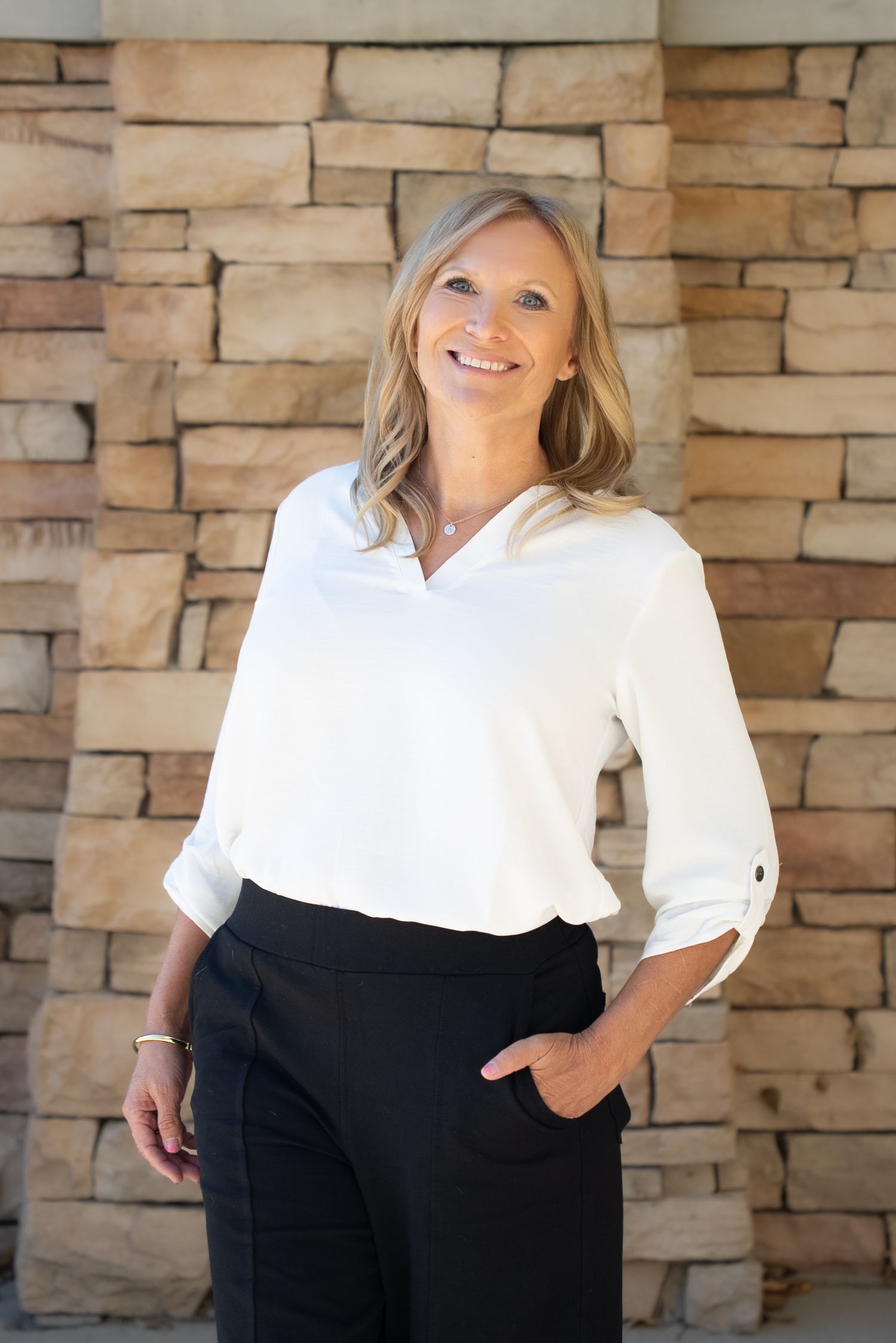 Head shot for an entrepreneur's website. Outdoors, stone backdrop, looking into camera. Different positions.