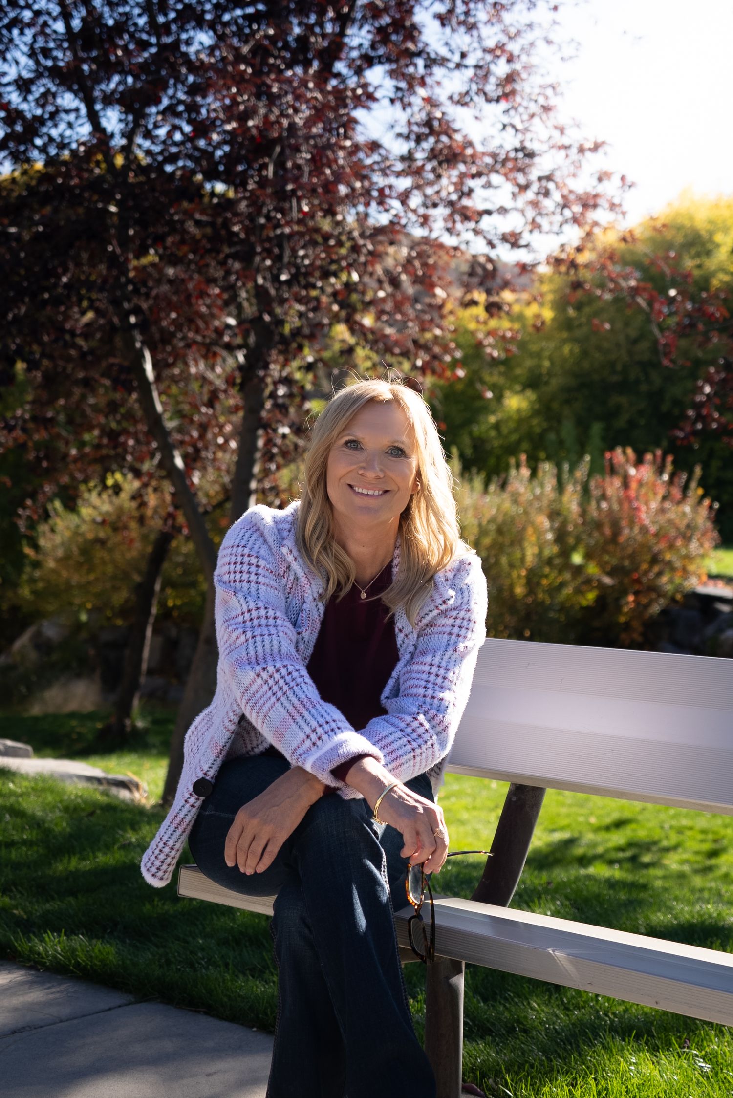 Head shot for an entrepreneur's website. Outdoors, sitting on bench, looking into camera. Different positions.