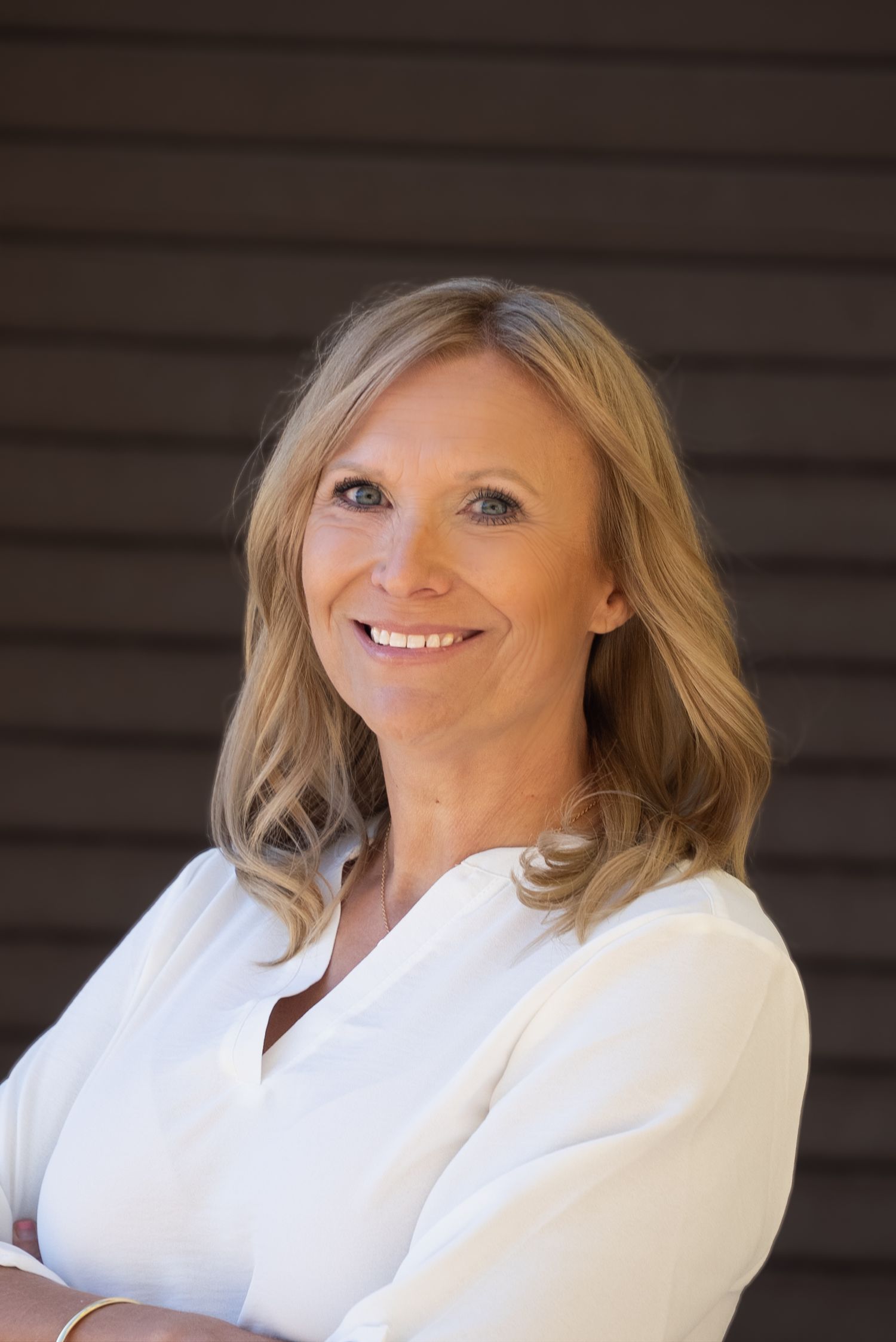 Head shot for an entrepreneur's website. Outdoors, dark background, looking into camera. Different positions.