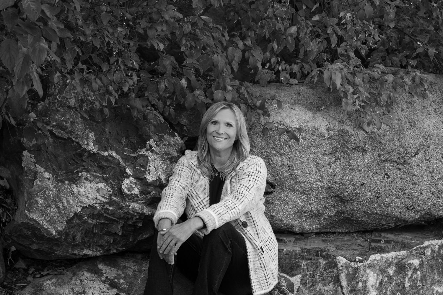 Head shot for an entrepreneur's website. Outdoors, black and white, sitting on rocks. Different positions.