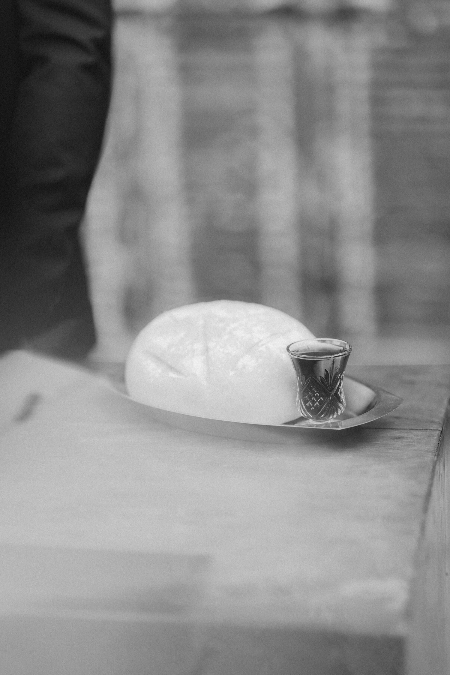 An artistic black and white detail shot of wedding ceremony elements.