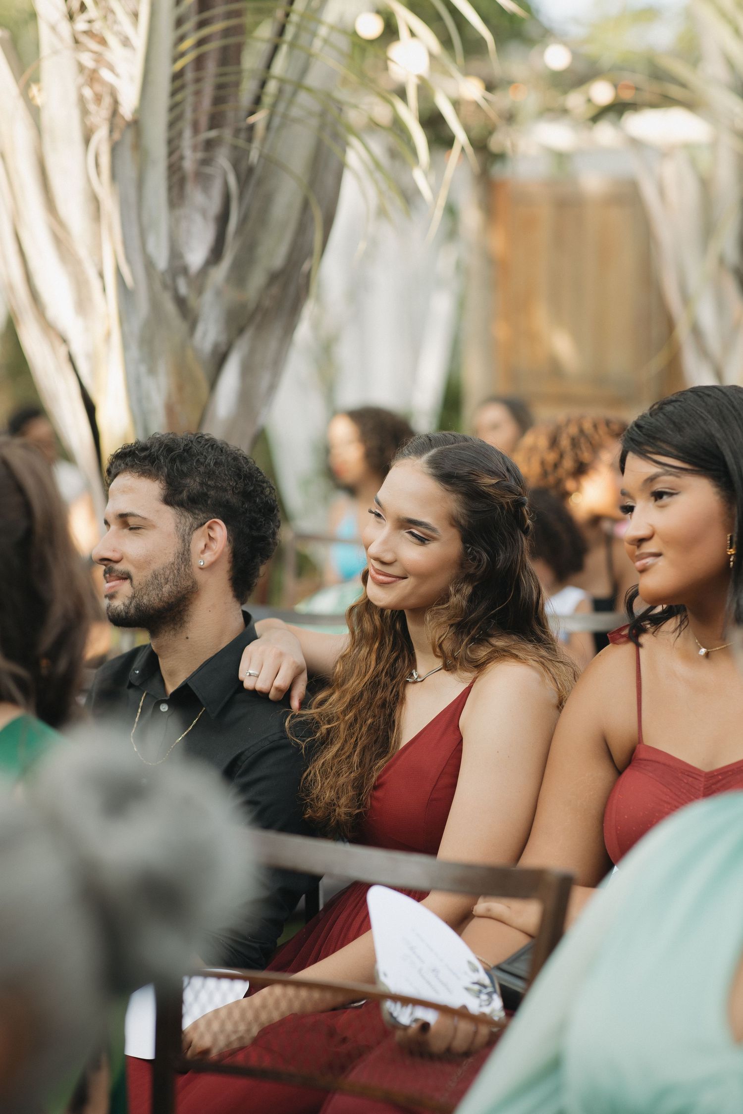 Wedding guests sharing smiles and laughter during an outdoor celebration.