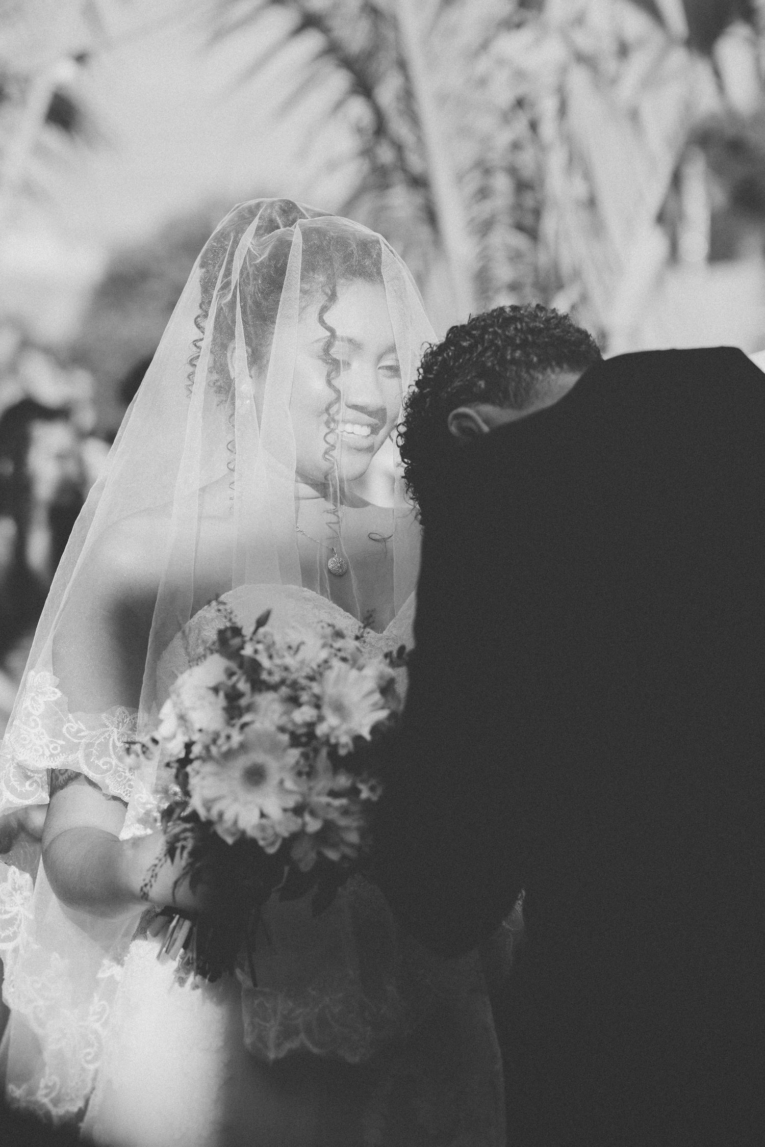 Close-up shots of a delicate white wedding veil with lace details.