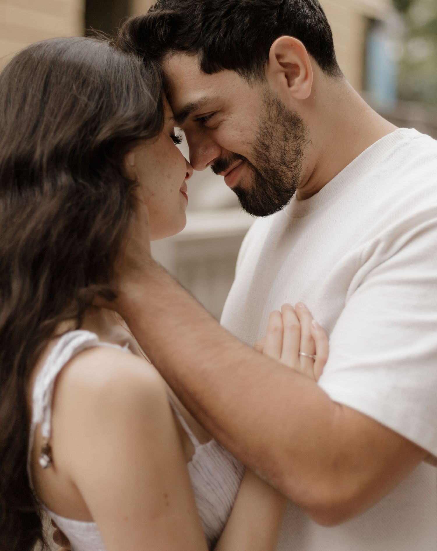 Intimate couple photography session with soft lighting and romantic poses in white outfits.