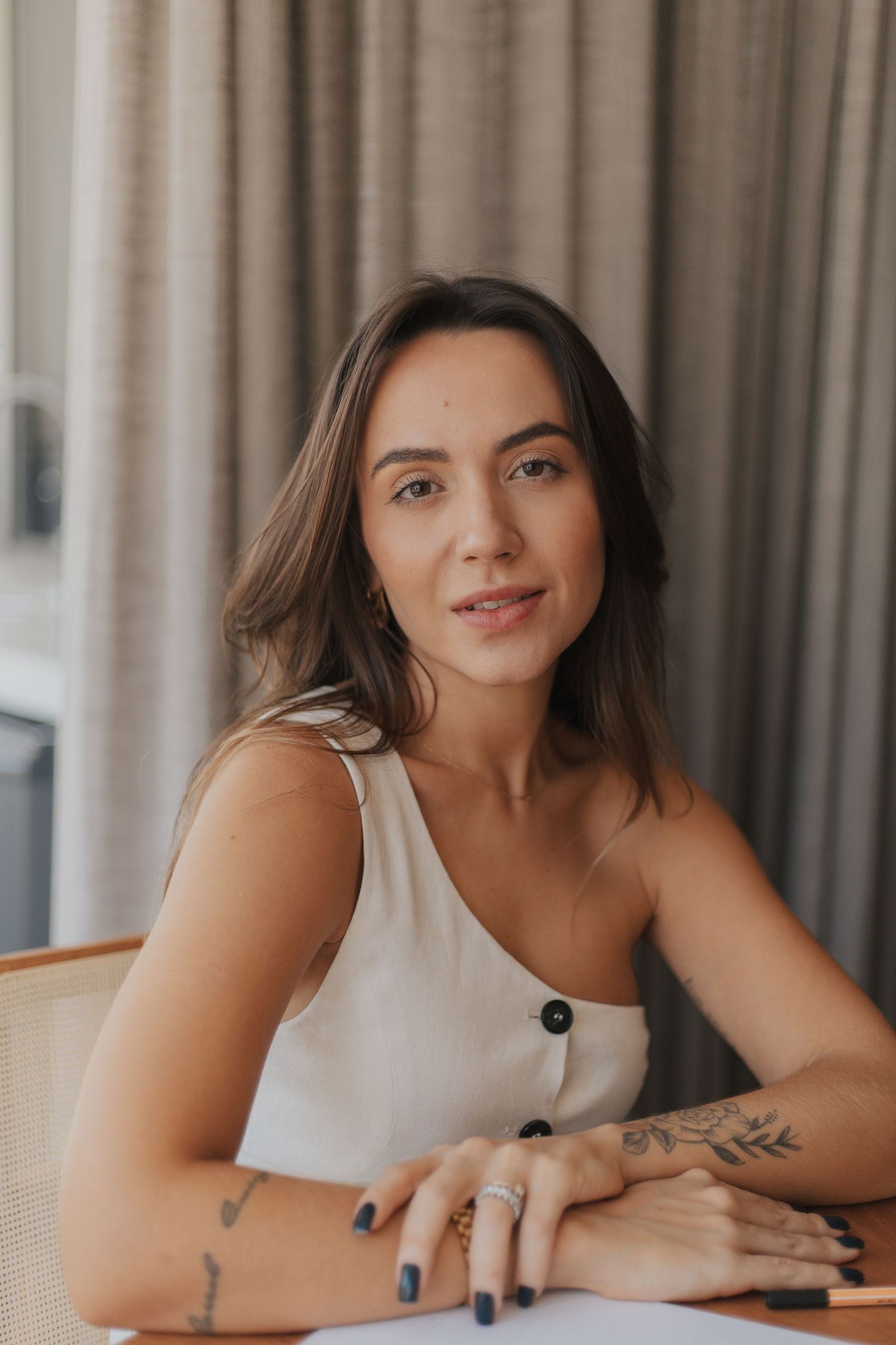 Casual indoor portrait session featuring relaxed poses against a neutral curtained backdrop.