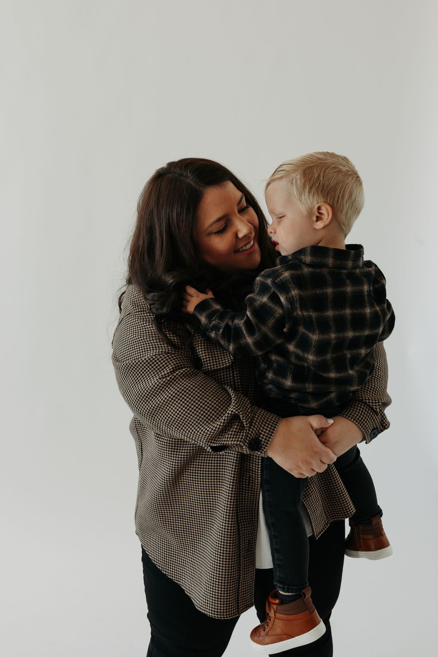 Heartwarming indoor portrait sequence showing tender moments between parent and child.