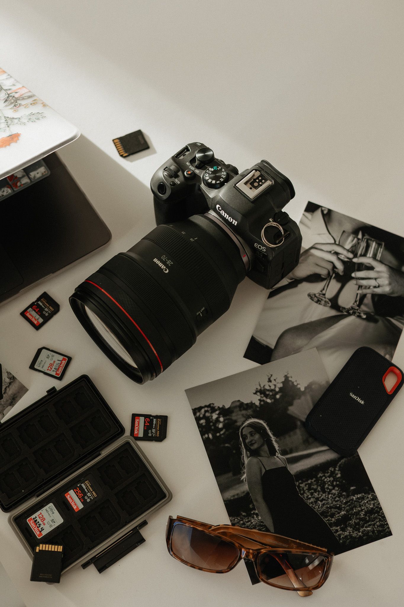 Collection of camera equipment and memory cards laid out on a white surface.