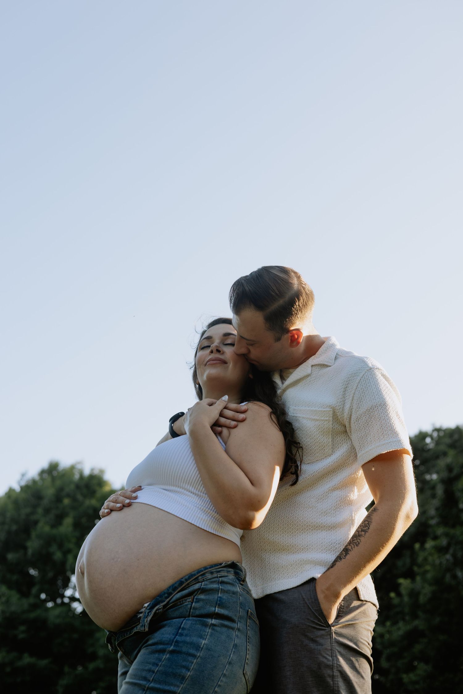 Romantic maternity photos between couple.