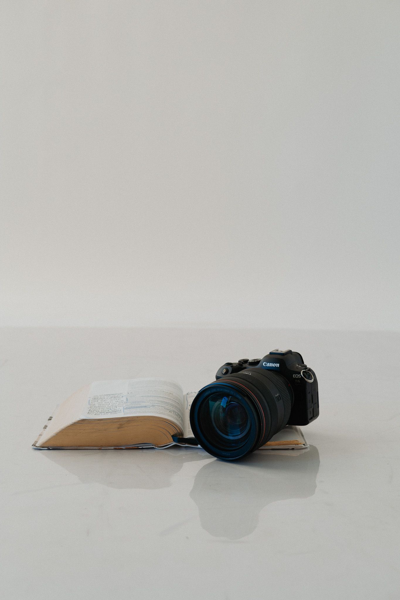 Professional camera equipment arranged in clean minimalist composition on white background.