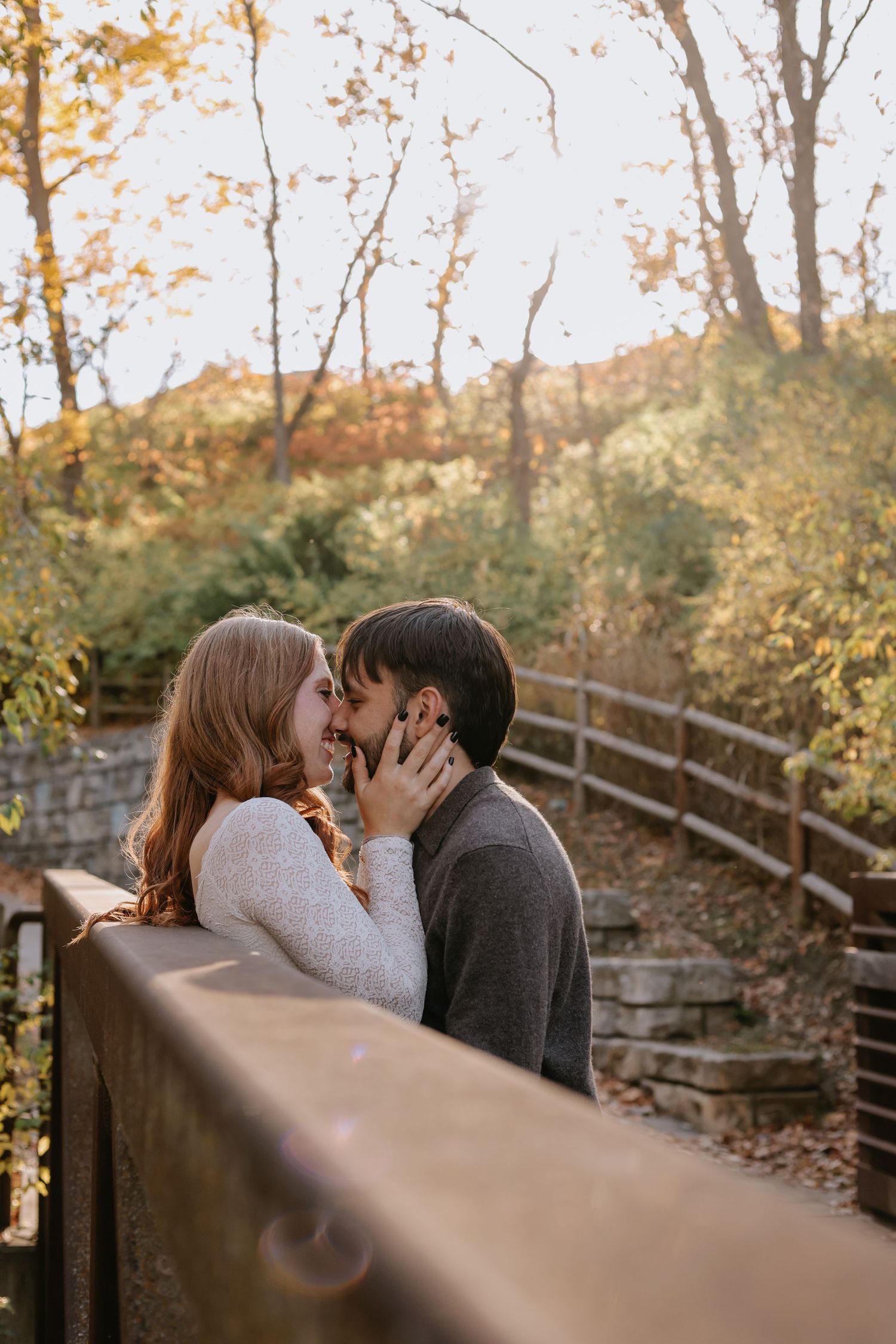 A tender moment captured on a wooden bridge during golden hour.