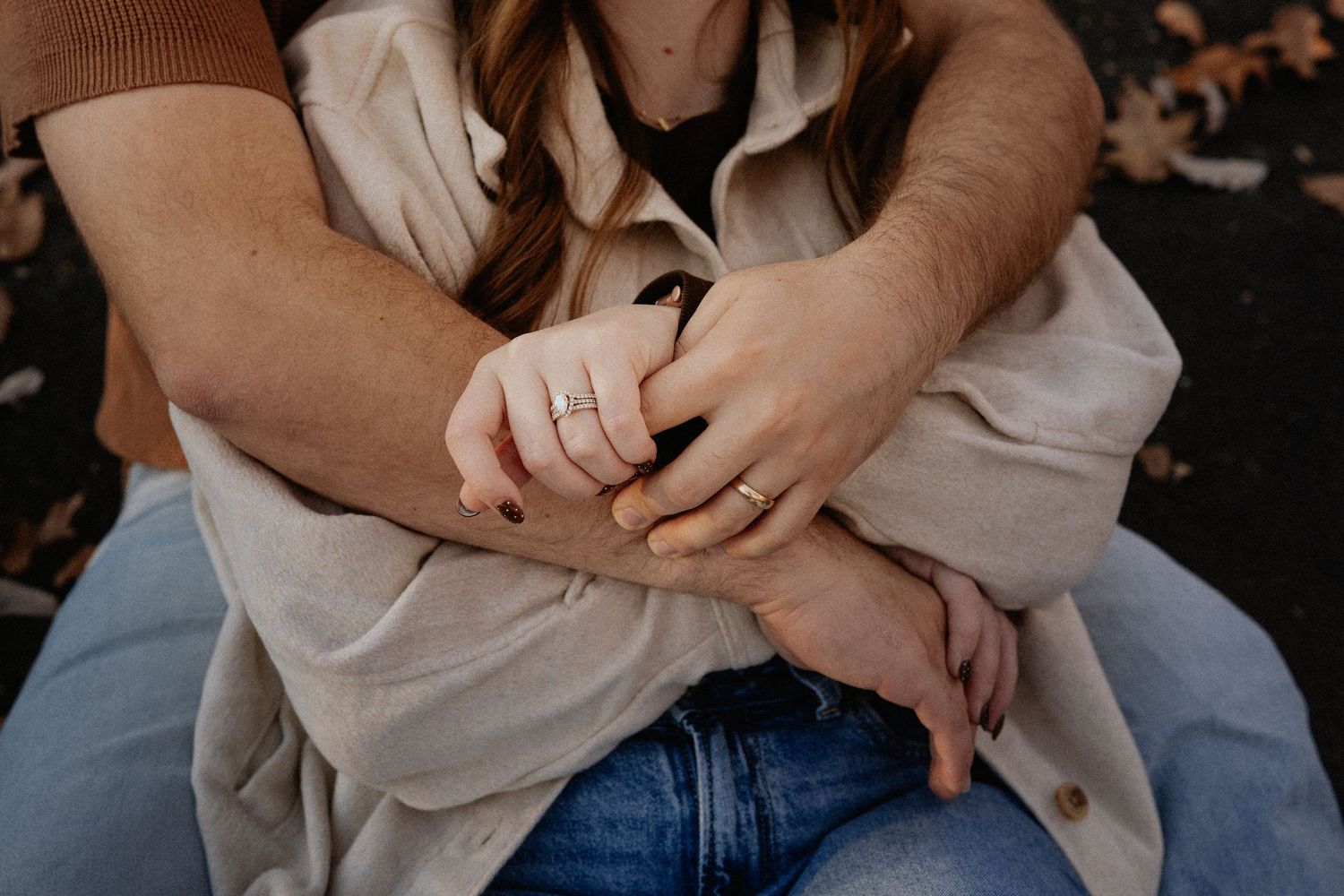 Intimate moment captured between couple sitting together outdoors.