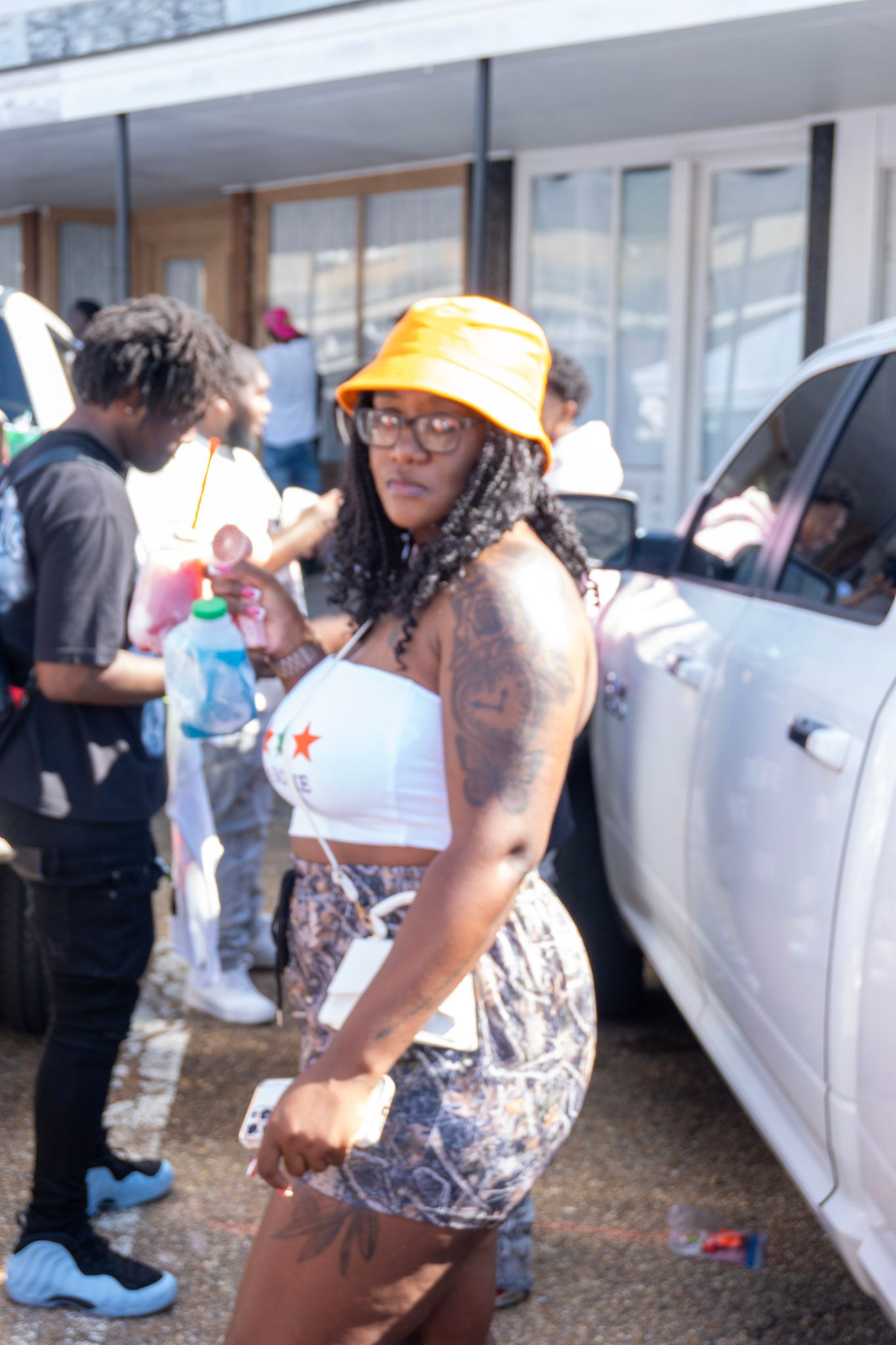 Attendees socializing outside a building during a daytime community event.