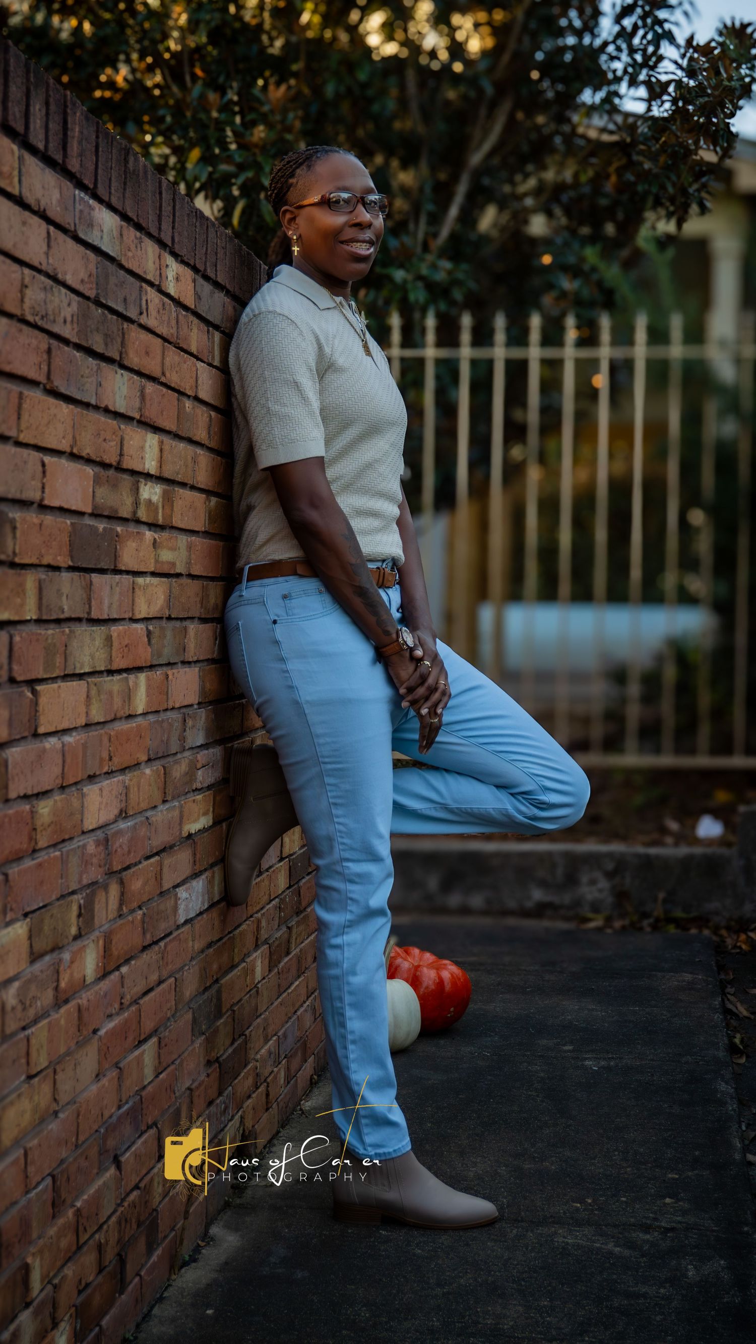 Brick wall backdrop with light denim and casual autumn styling.