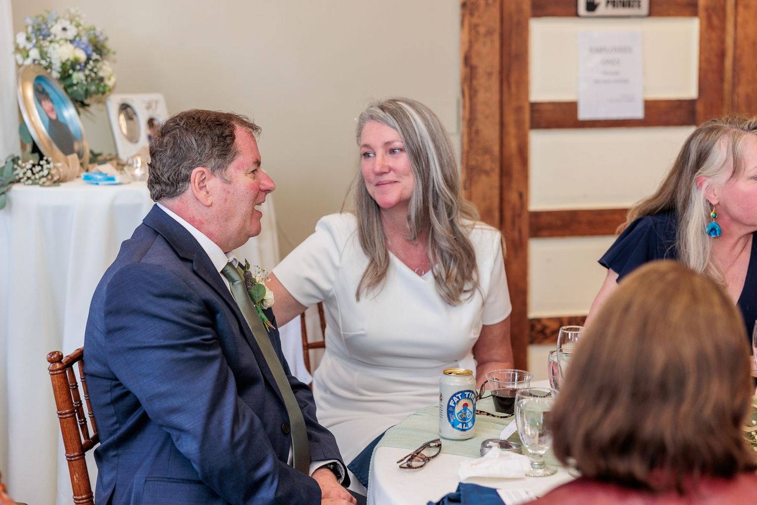 Reception celebration inside a rustic wooden lodge with elegant table settings and floral arrangements.