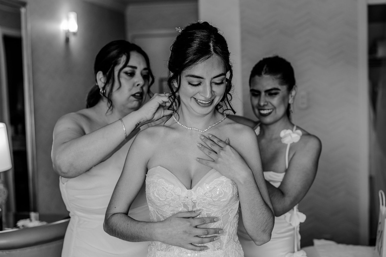 Emotional moments shared between wedding party members in black and white photography.