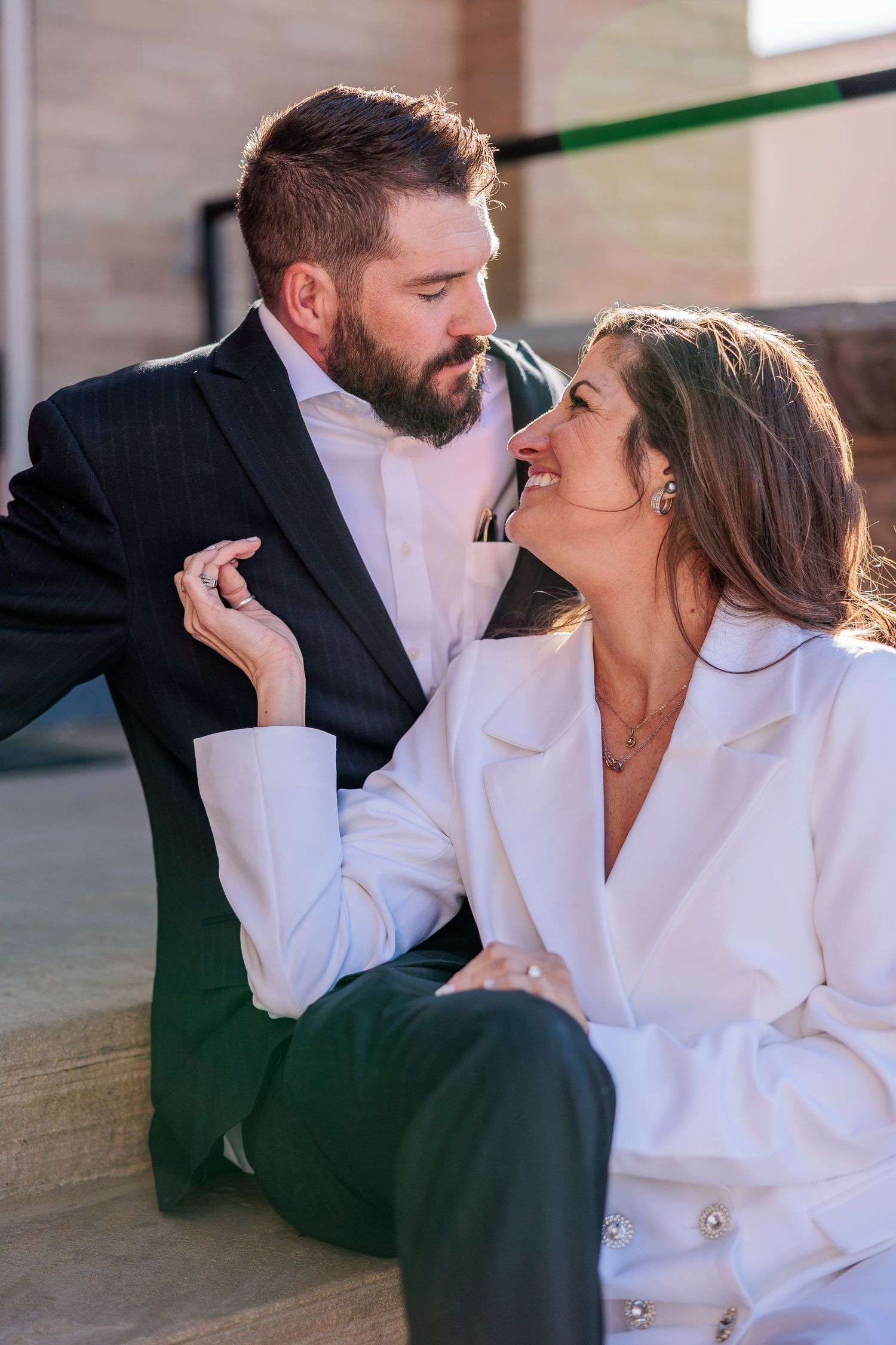 A romantic couple in white and black clothing share intimate moments in a series of connected photographs.