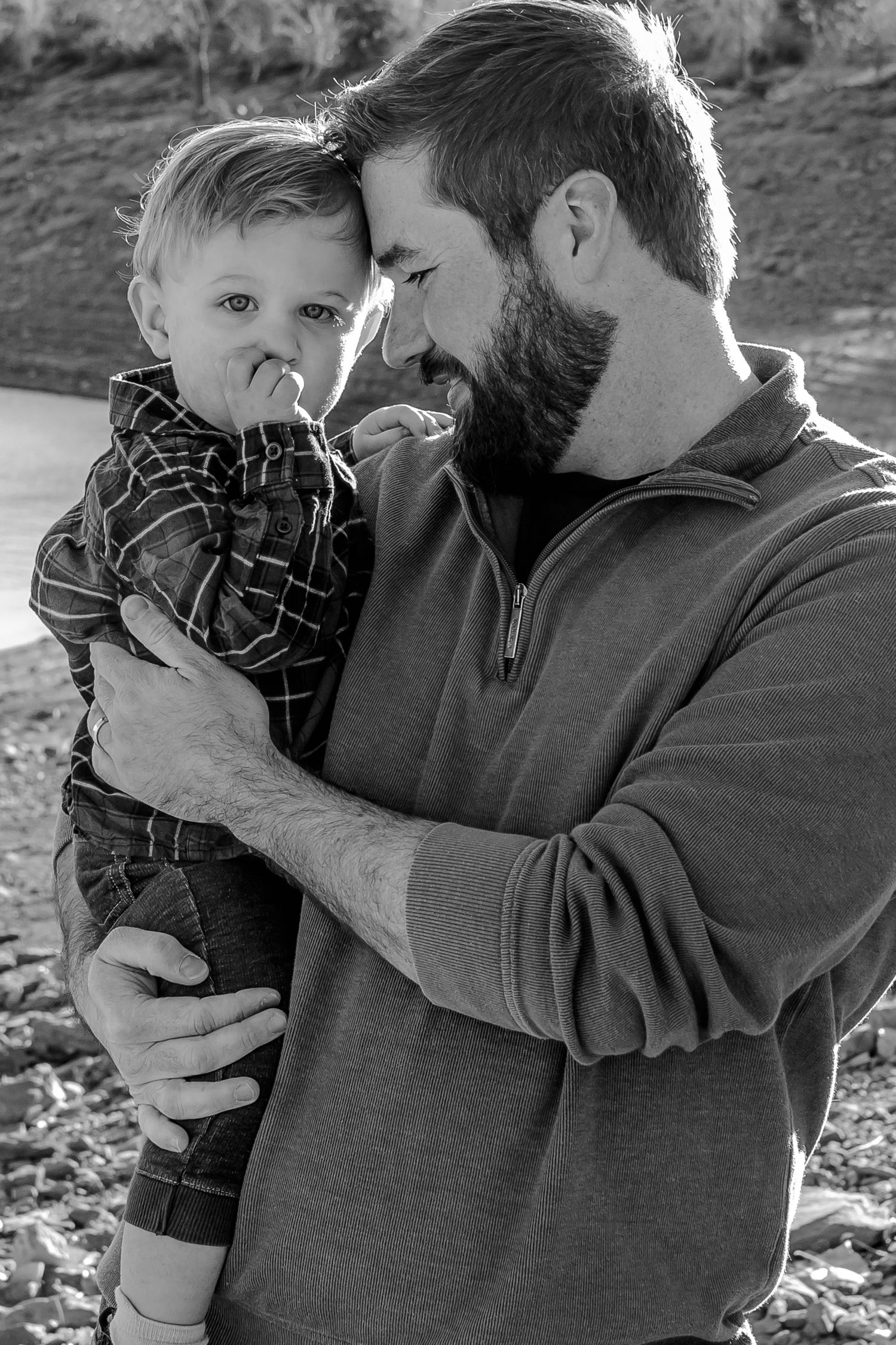 A heartwarming black and white photo sequence showing tender moments between parent and child outdoors.