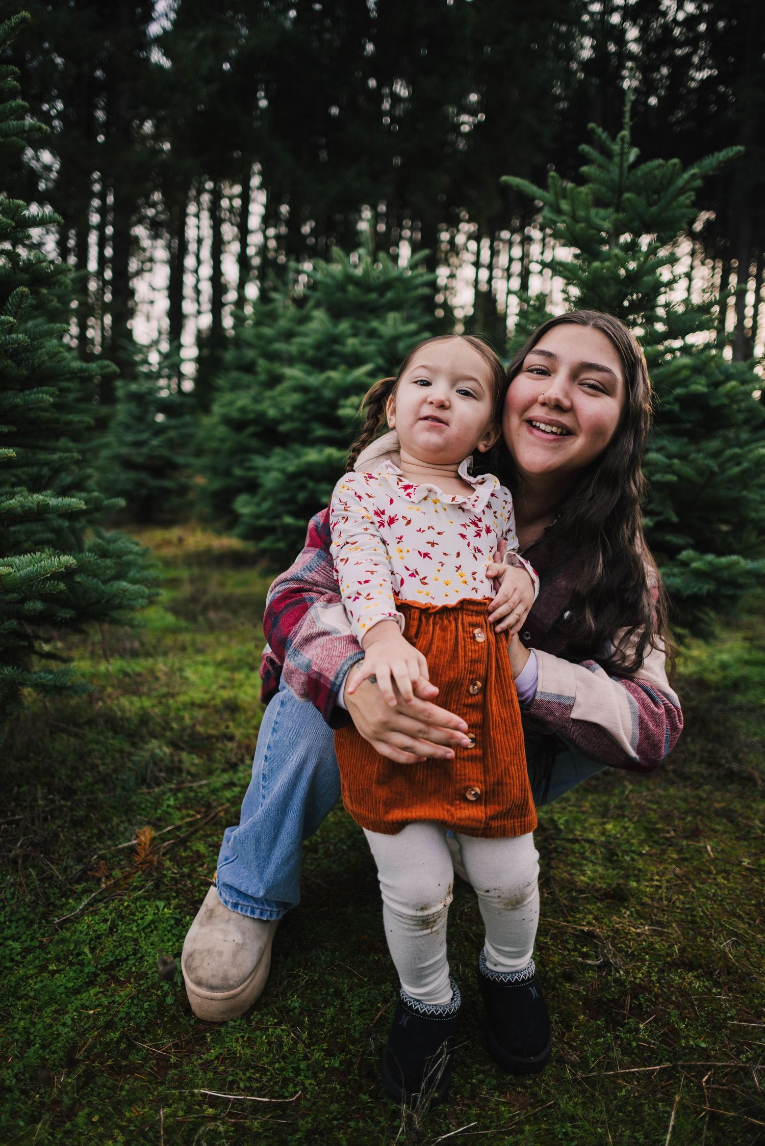 A series of candid moments in a pine forest showing joyful interactions between two people in casual autumn attire.