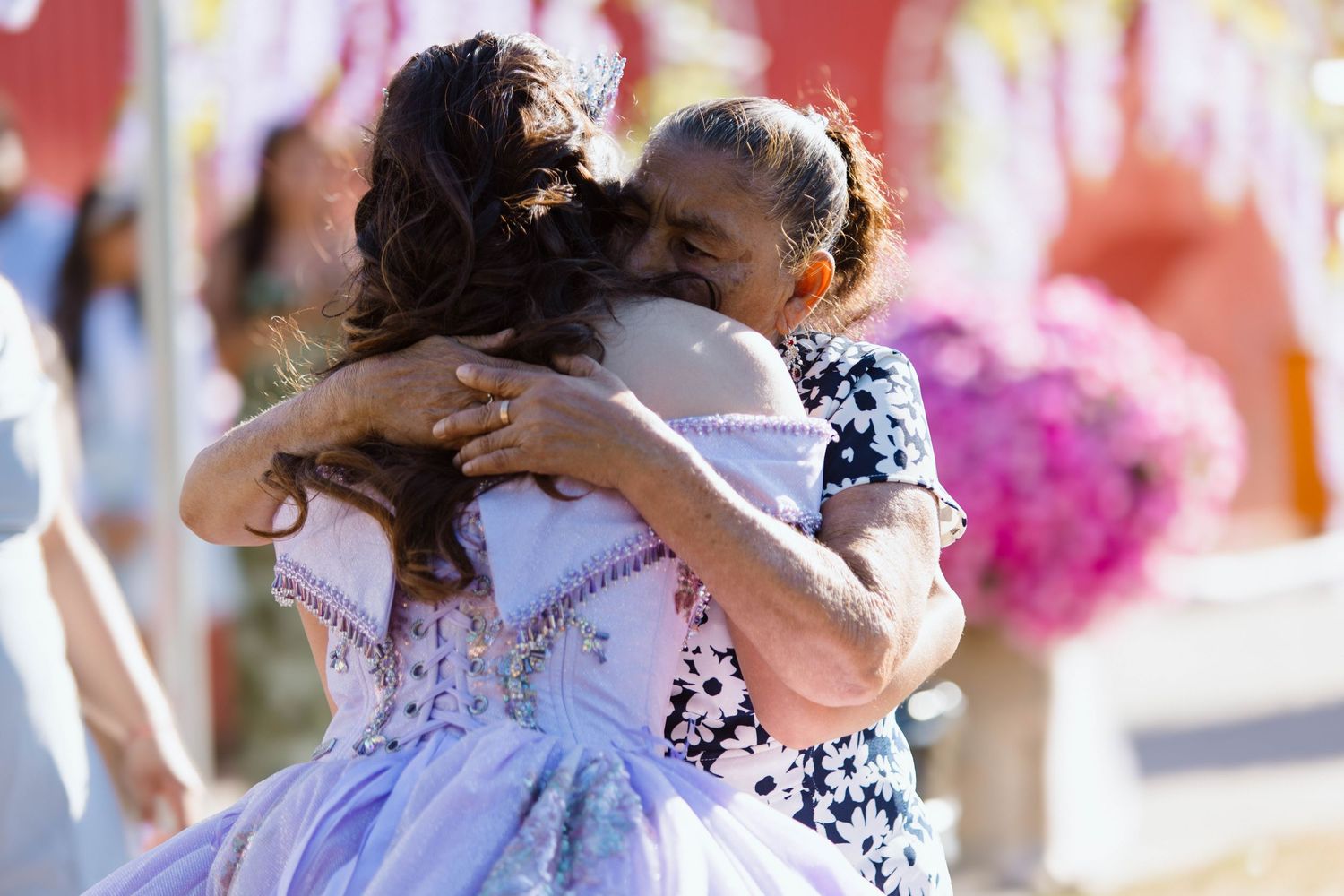 People dancing together in formal attire at an outdoor celebration event.