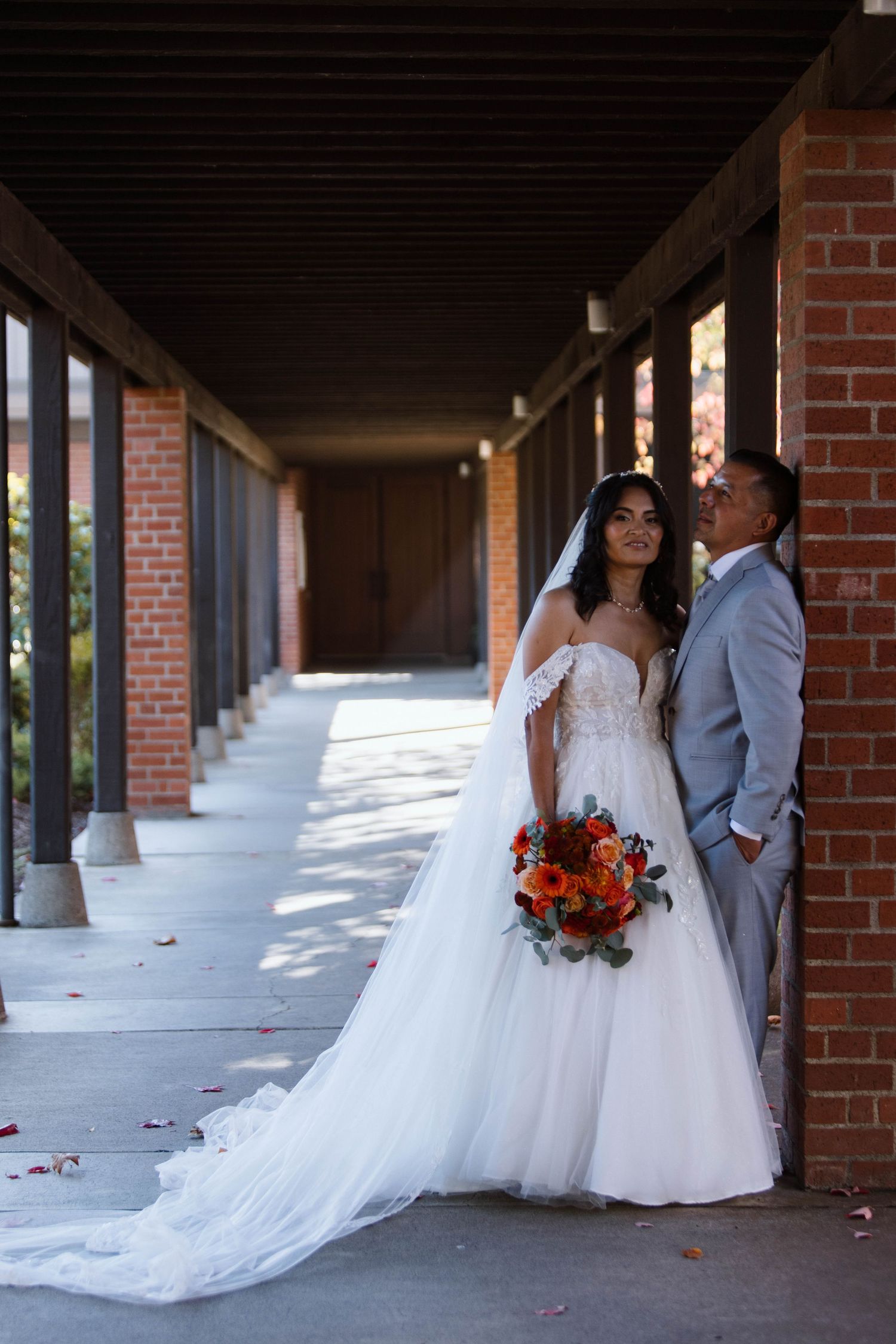 Series of wedding photos showing couples posing under a brick archway with flowing white dresses and floral bouquets.