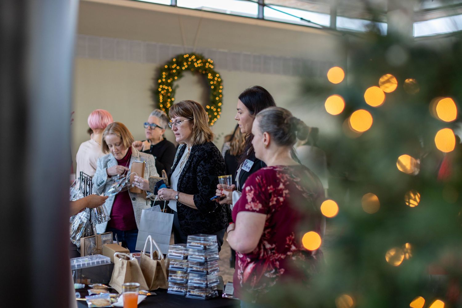 Guests mingle and socialize during an elegant evening reception with warm lighting and festive decorations.