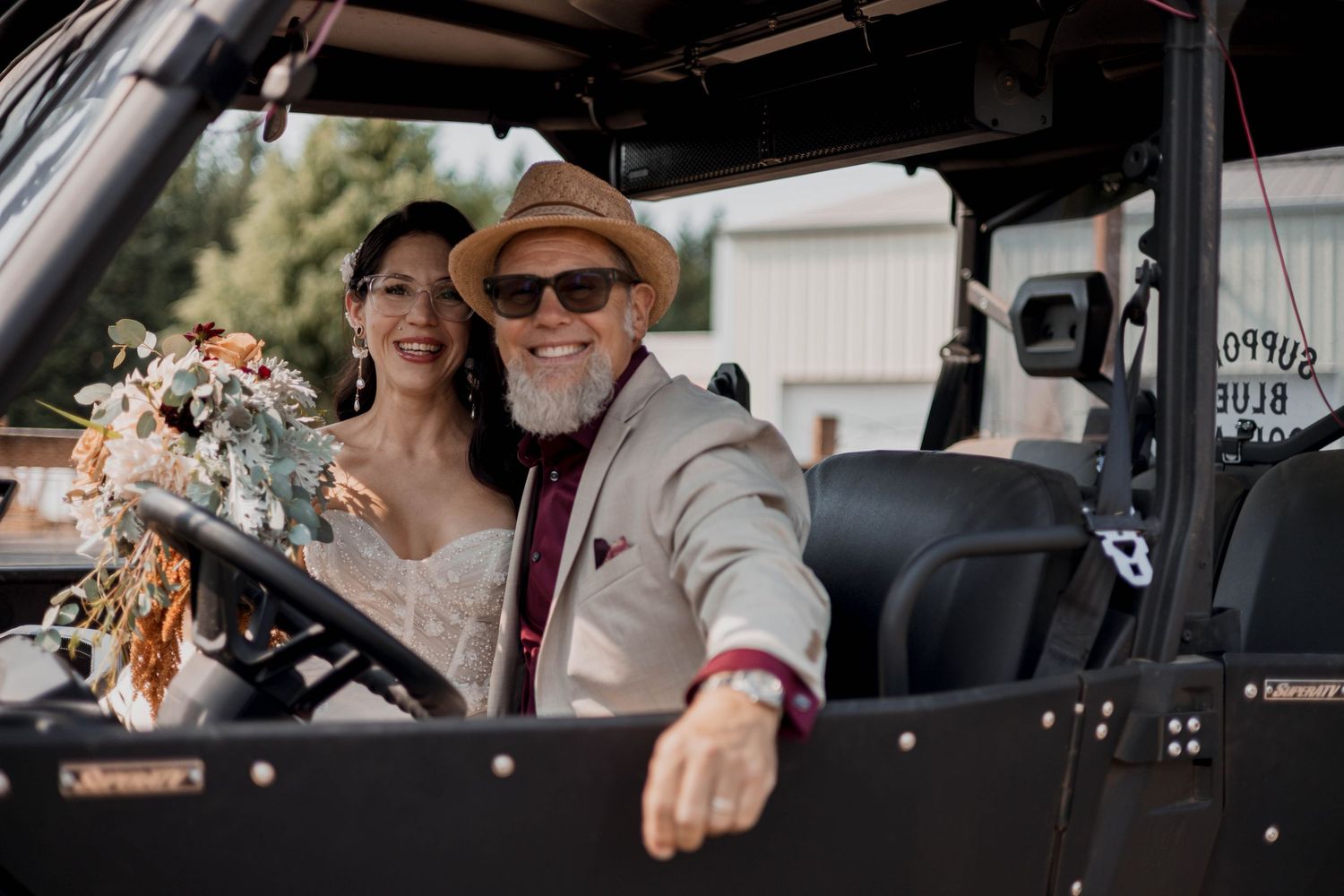 Vintage car interior view showing a leather steering wheel and dashboard during a wedding celebration.