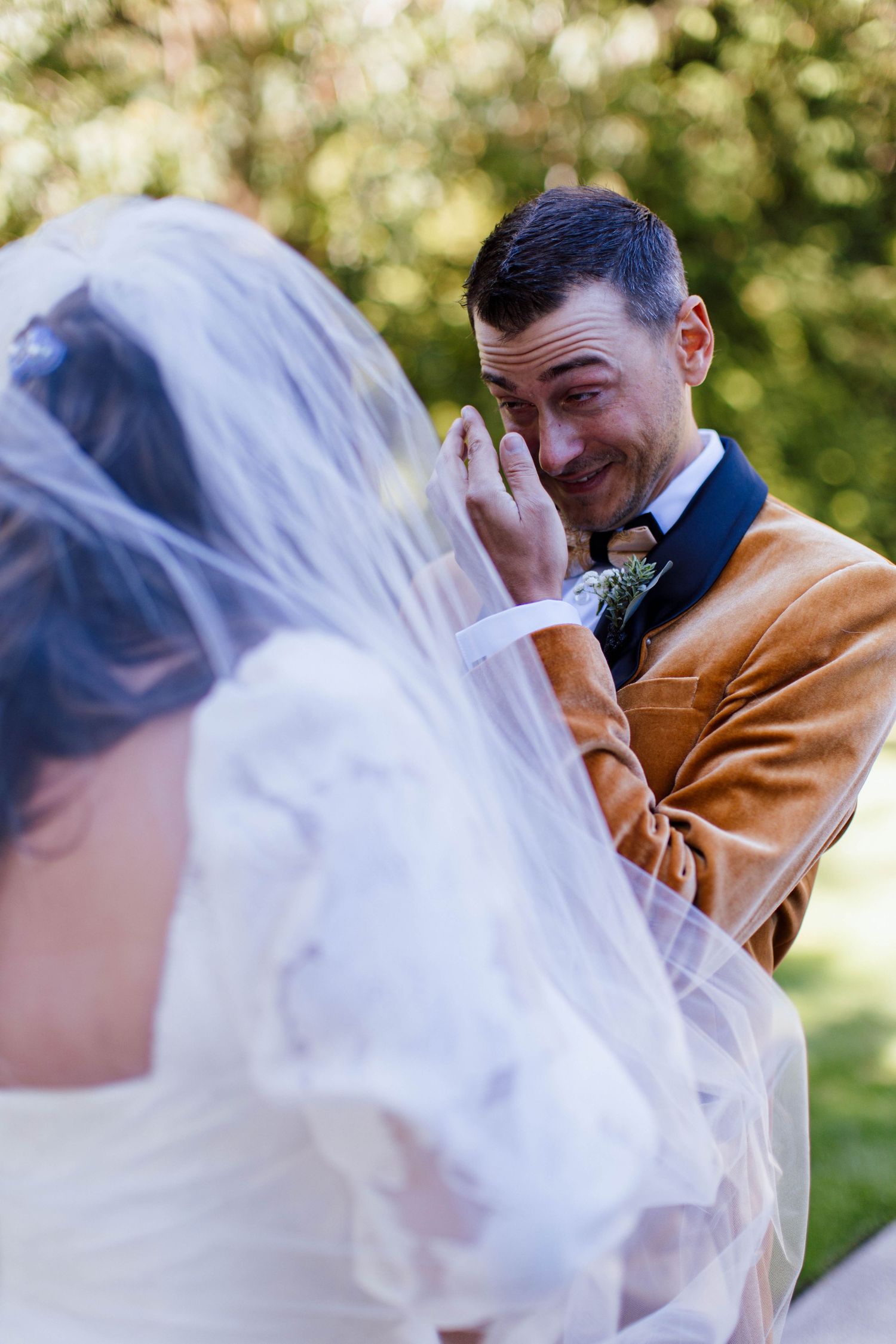 A series of wedding photos showing emotional reactions between a bride and groom during their first look moment.