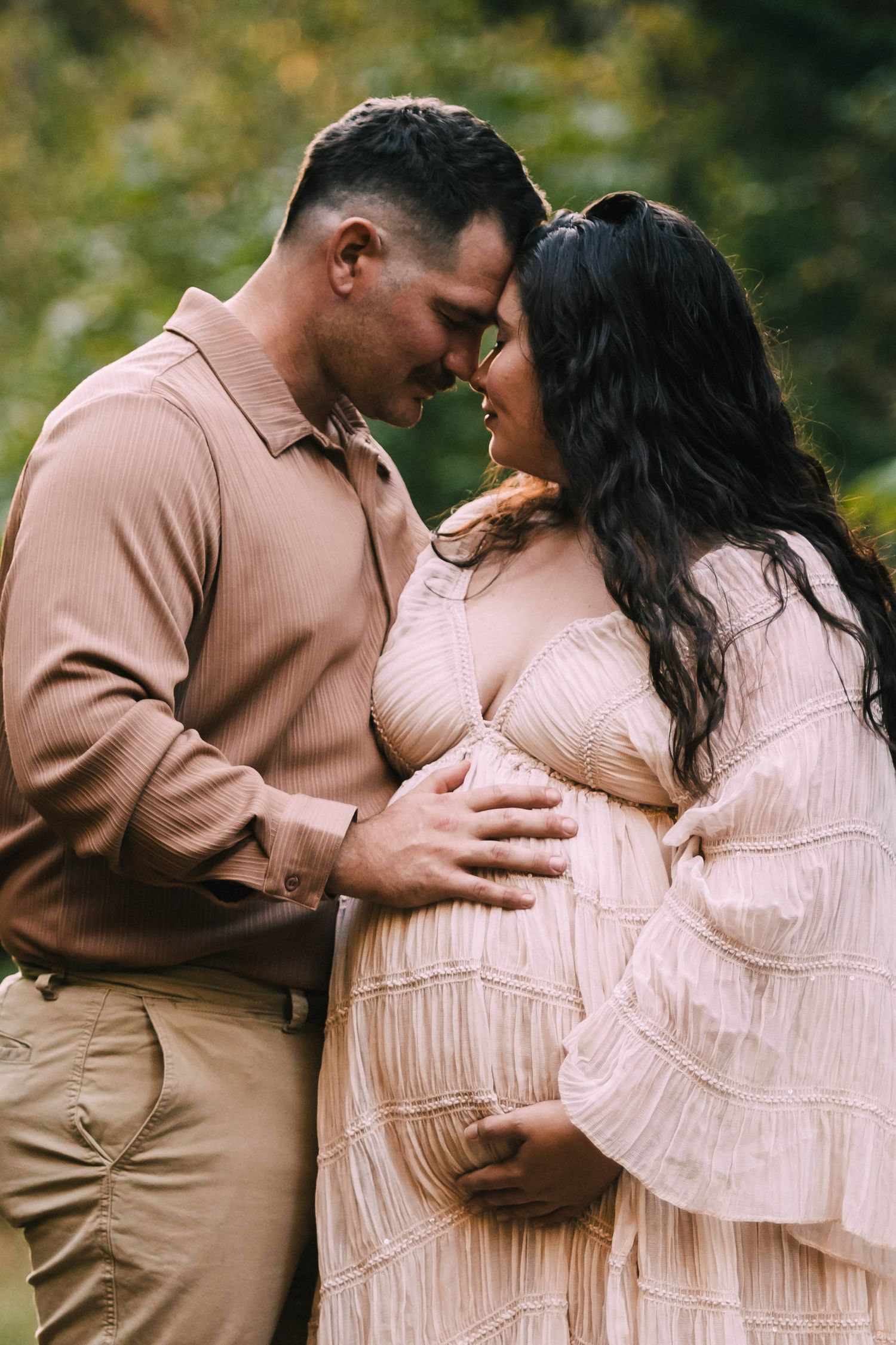 A romantic couple in matching beige and pink outfits share tender moments in a series of intimate outdoor photos.
