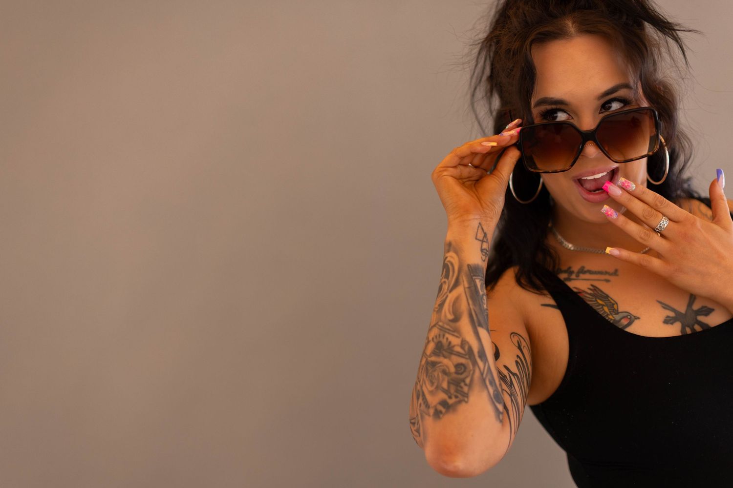 A collection of six photos showing someone in black clothing posing against different backgrounds.