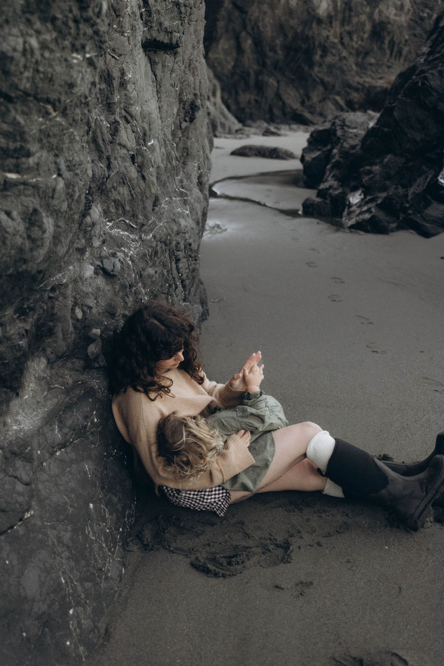 A mother nursing her daughter on the beach during an intimate sunrise photoshoot