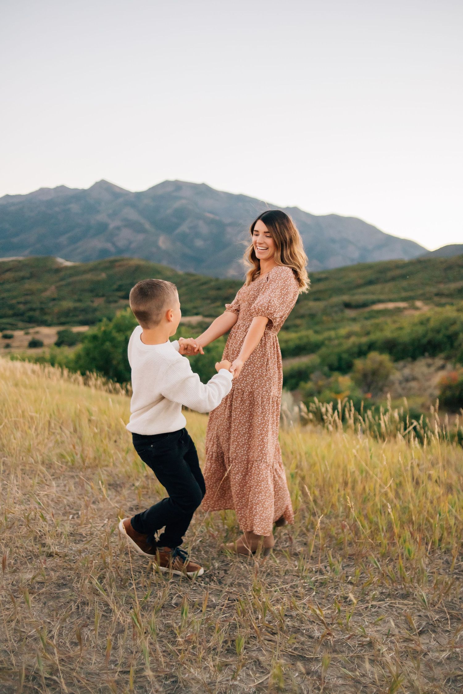 A mom and son candidly playing during an outdoor mountain family photo shoot