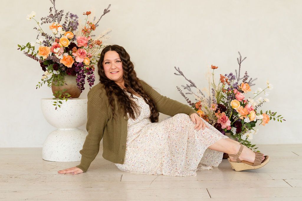 A young woman who has no children of her own but is being celebrated during an indoor mother's day portrait session